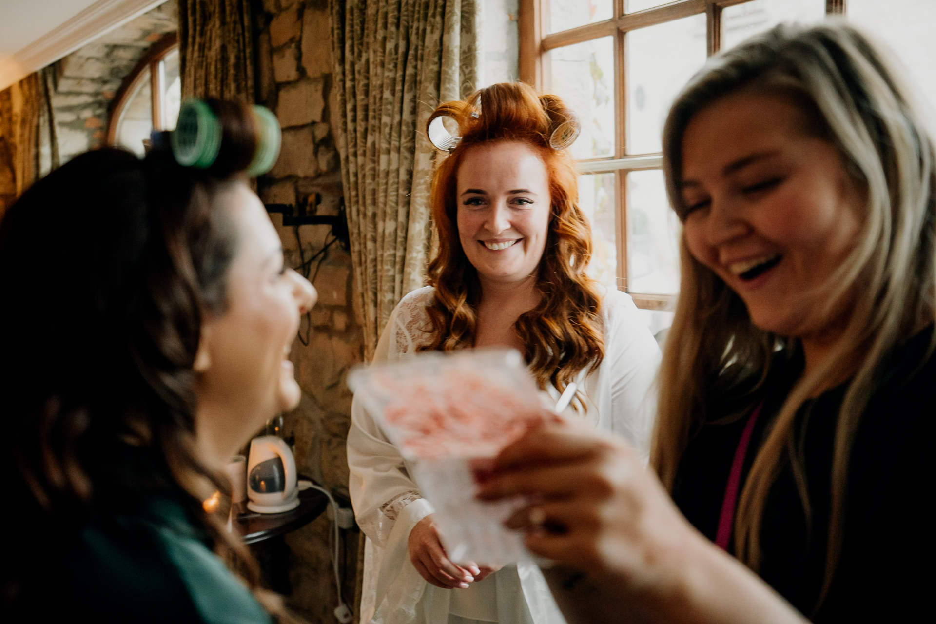 Bridesmaids celebrating with the bride during wedding morning preparations at Cabra Castle.