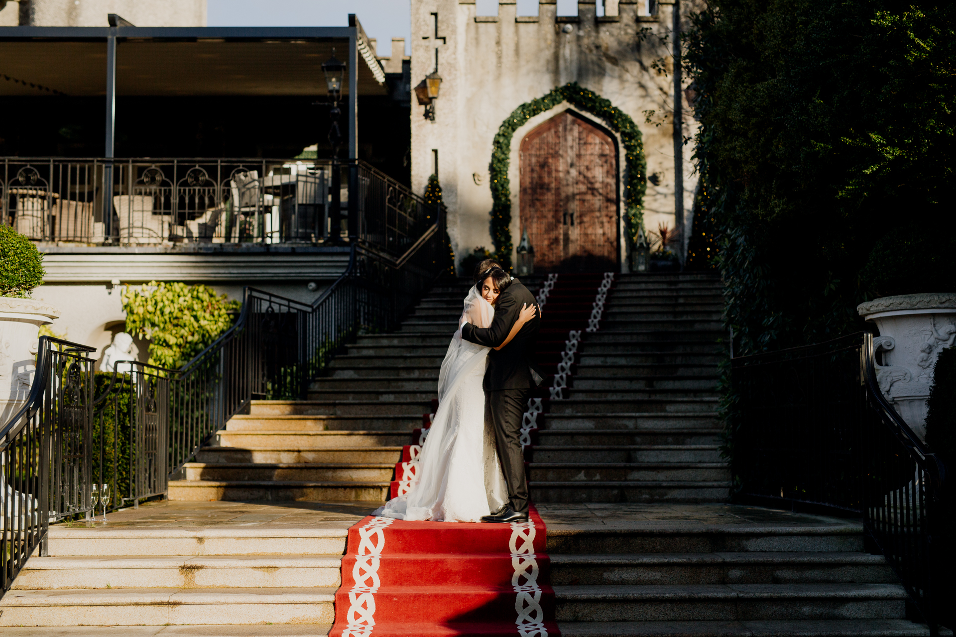 Bride and groom kiss on the grand staircase at Cabra Castle Wedding during their First Look