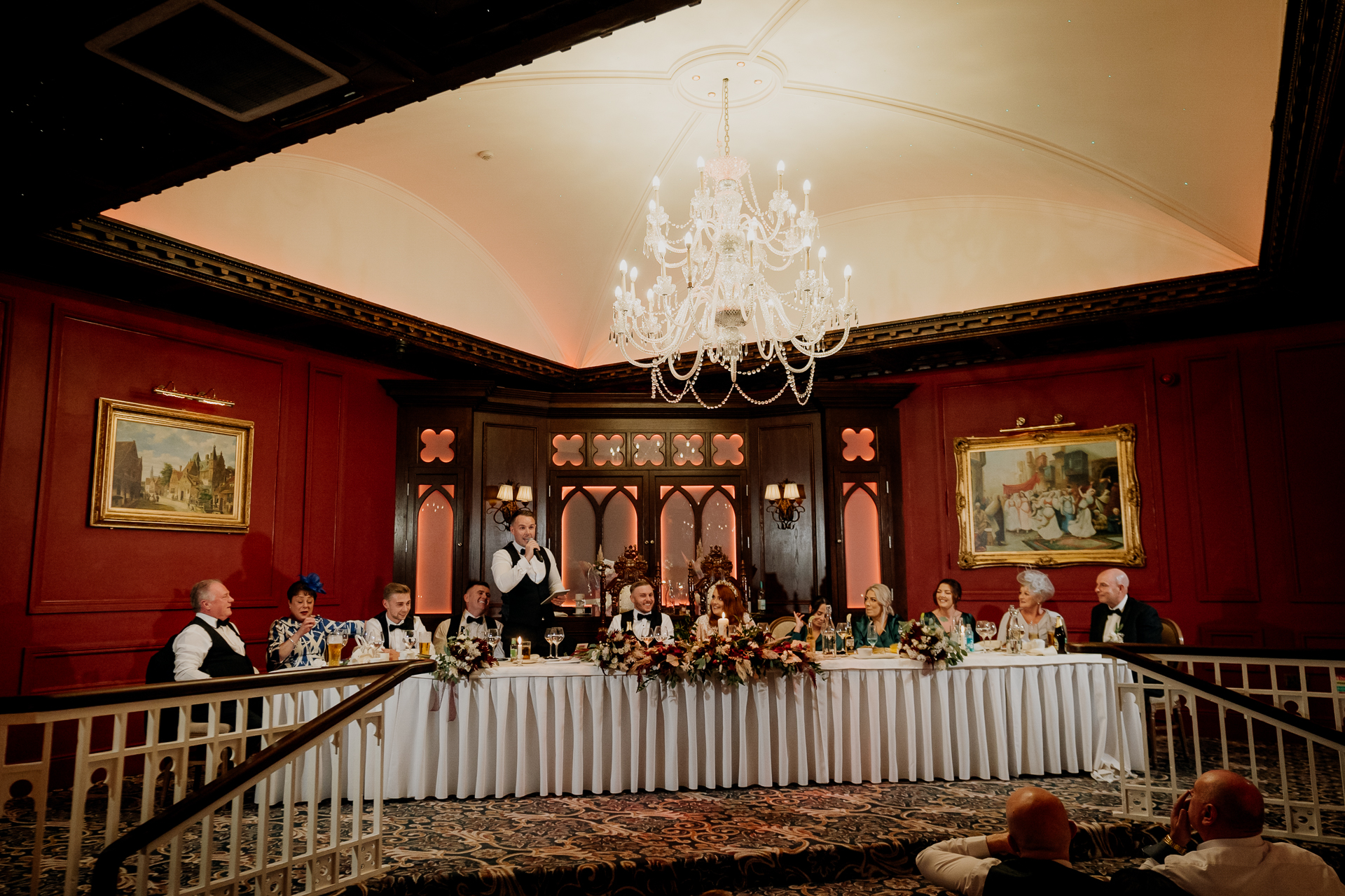 Cabra Castle Wedding reception speeches in the grand ballroom with long table and chandeliers