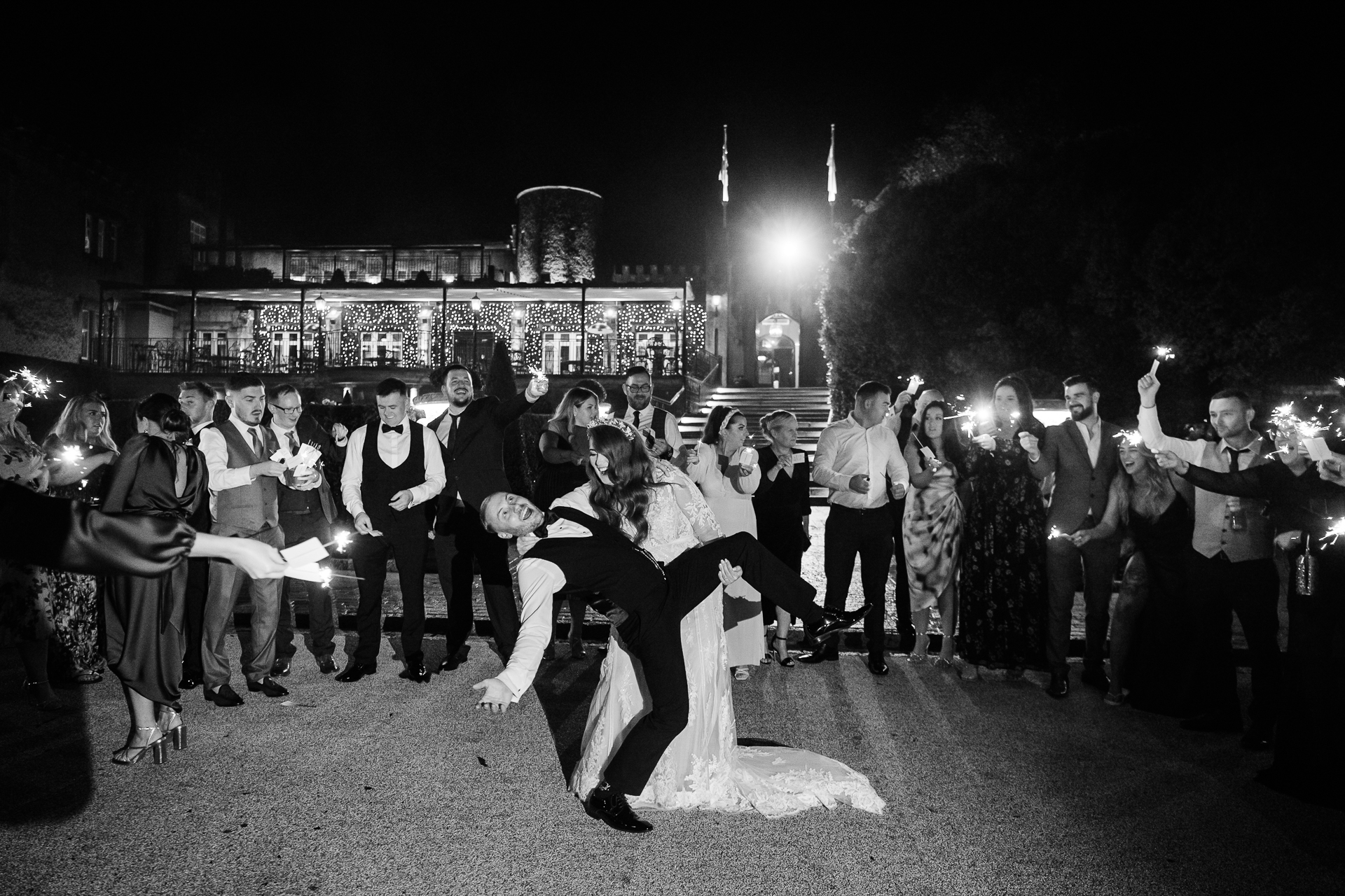 Cabra Castle Wedding sparkler exit with bride and groom kissing outside at night