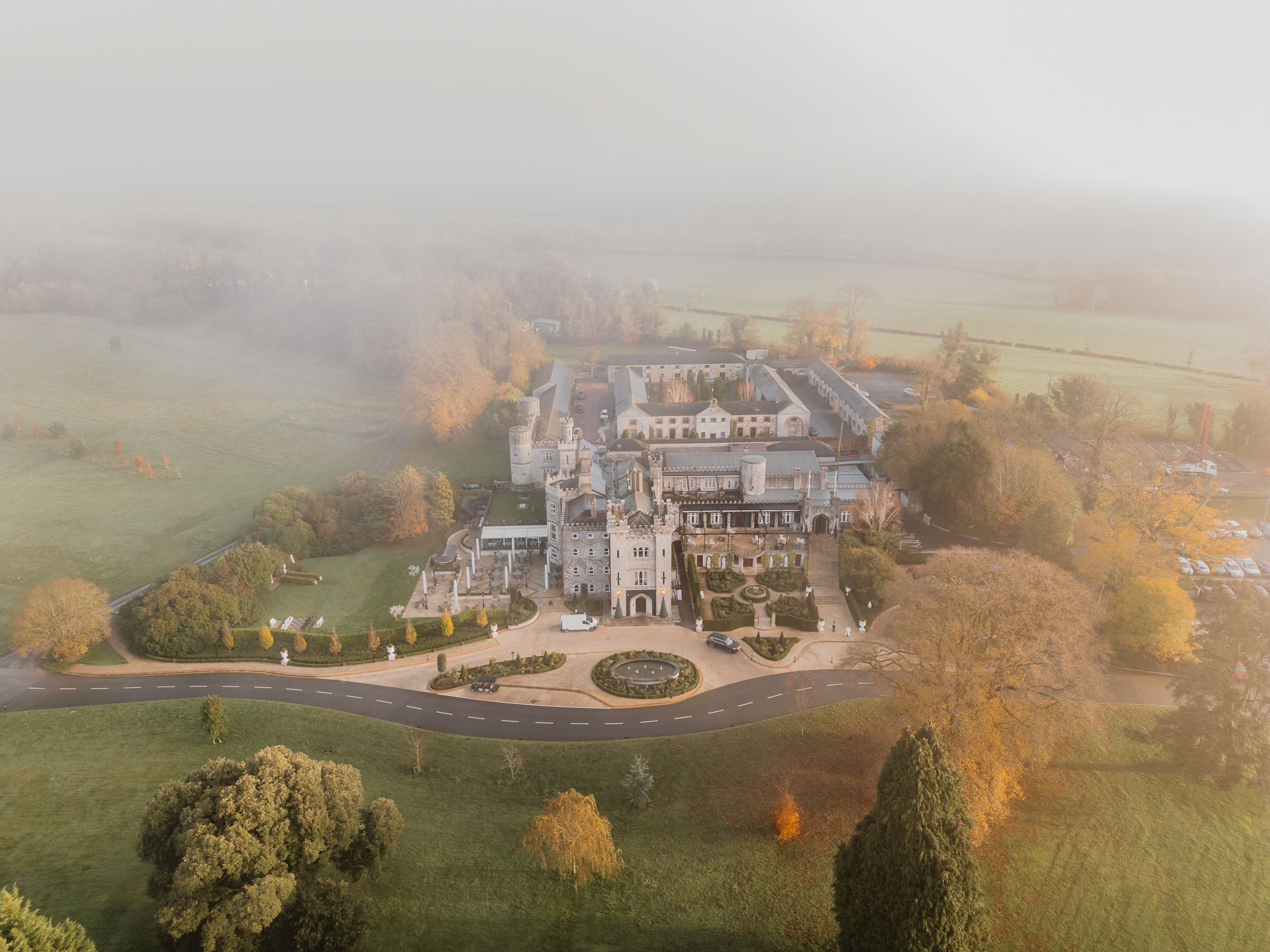Aerial view of Cabra Castle covered in winter mist, surrounded by trees and gardens – Dublin Wedding Photographer