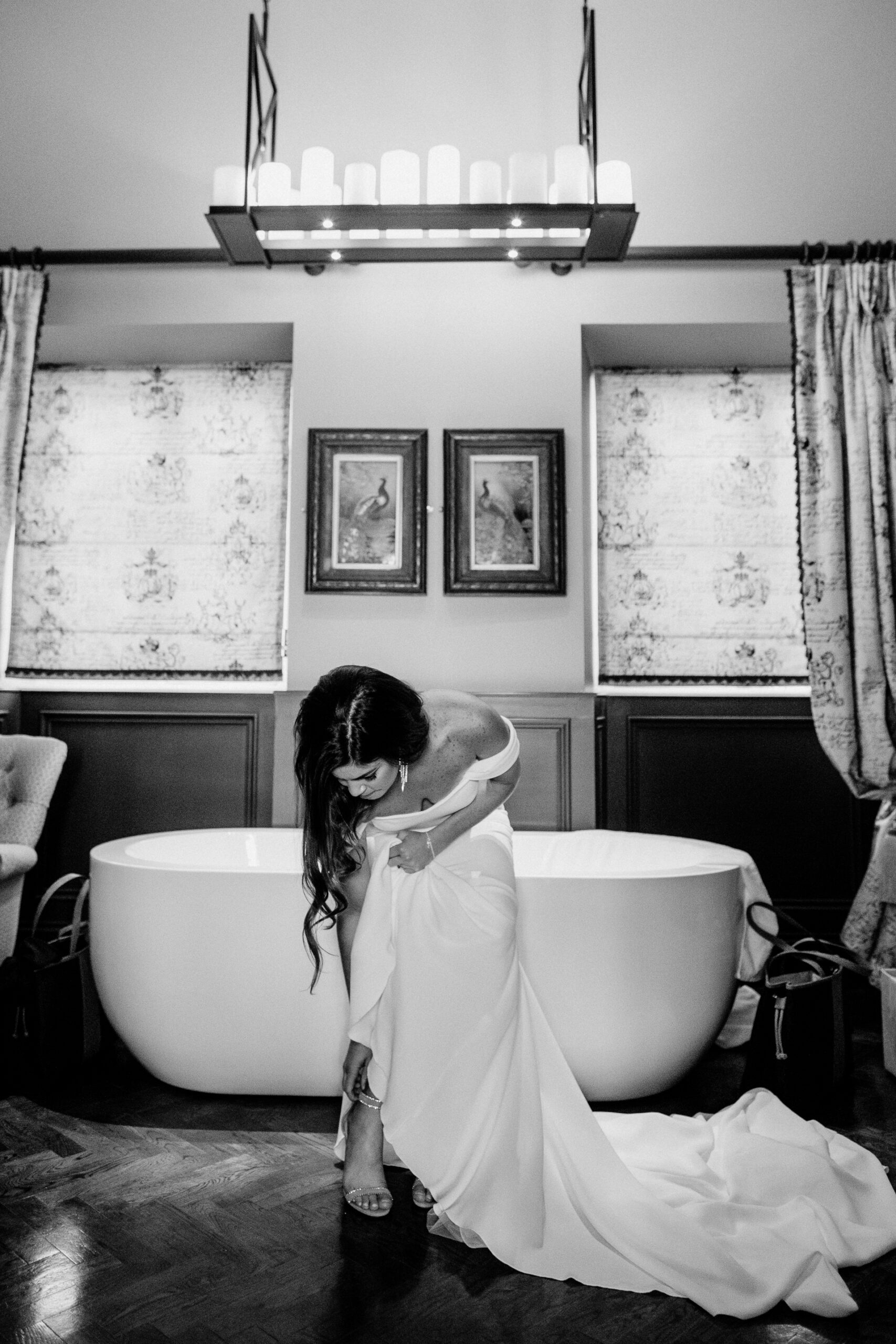 Bride adjusting her wedding dress inside the elegant bridal suite at Markree Castle, Ireland