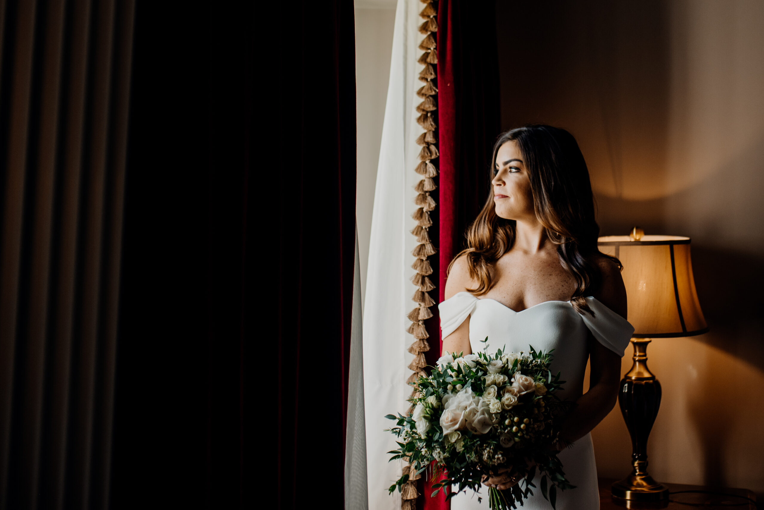 Bride holding bouquet by the window – soft light portrait at Markree Castle