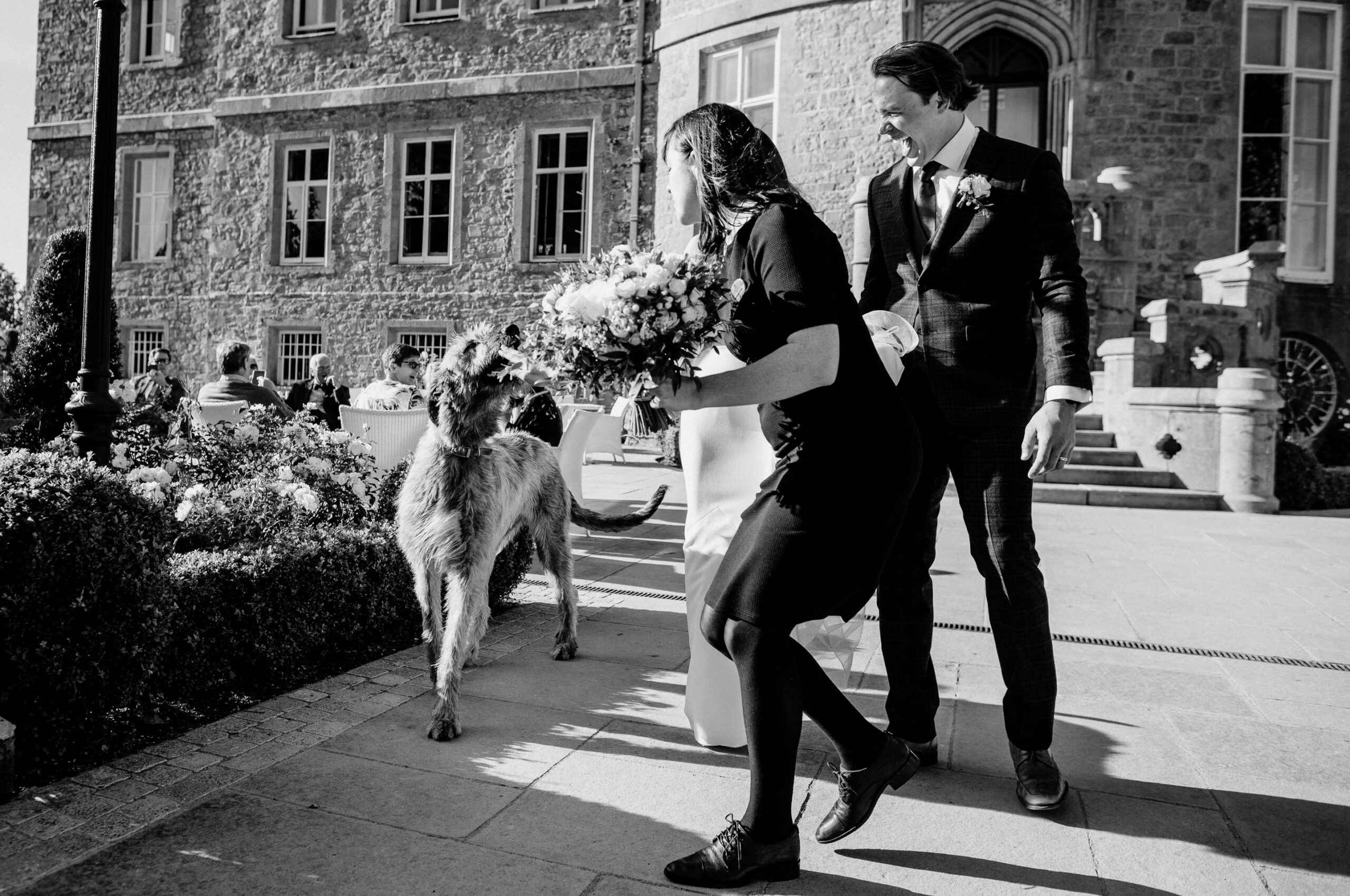 Bride and groom walking with their dog outside Markree Castle – candid destination wedding photo Ireland