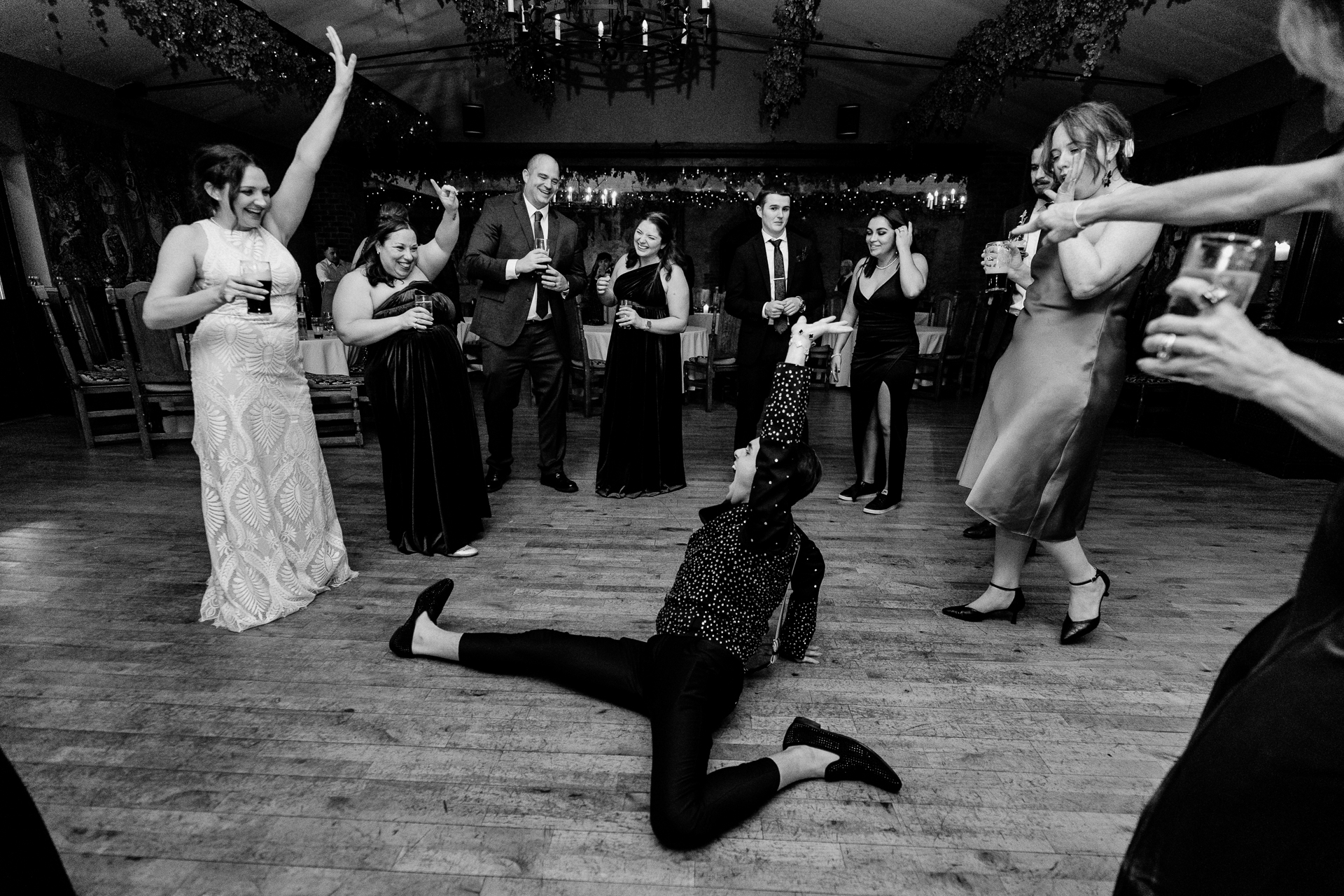 Candid shot of smiling wedding guest in green velvet during Dublin wedding ceremony