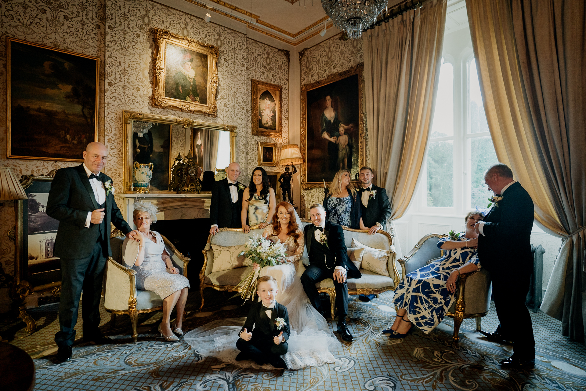 Wedding guests relaxing in a luxurious drawing room at Cabra Castle – Cabra Castle Wedding Photographer