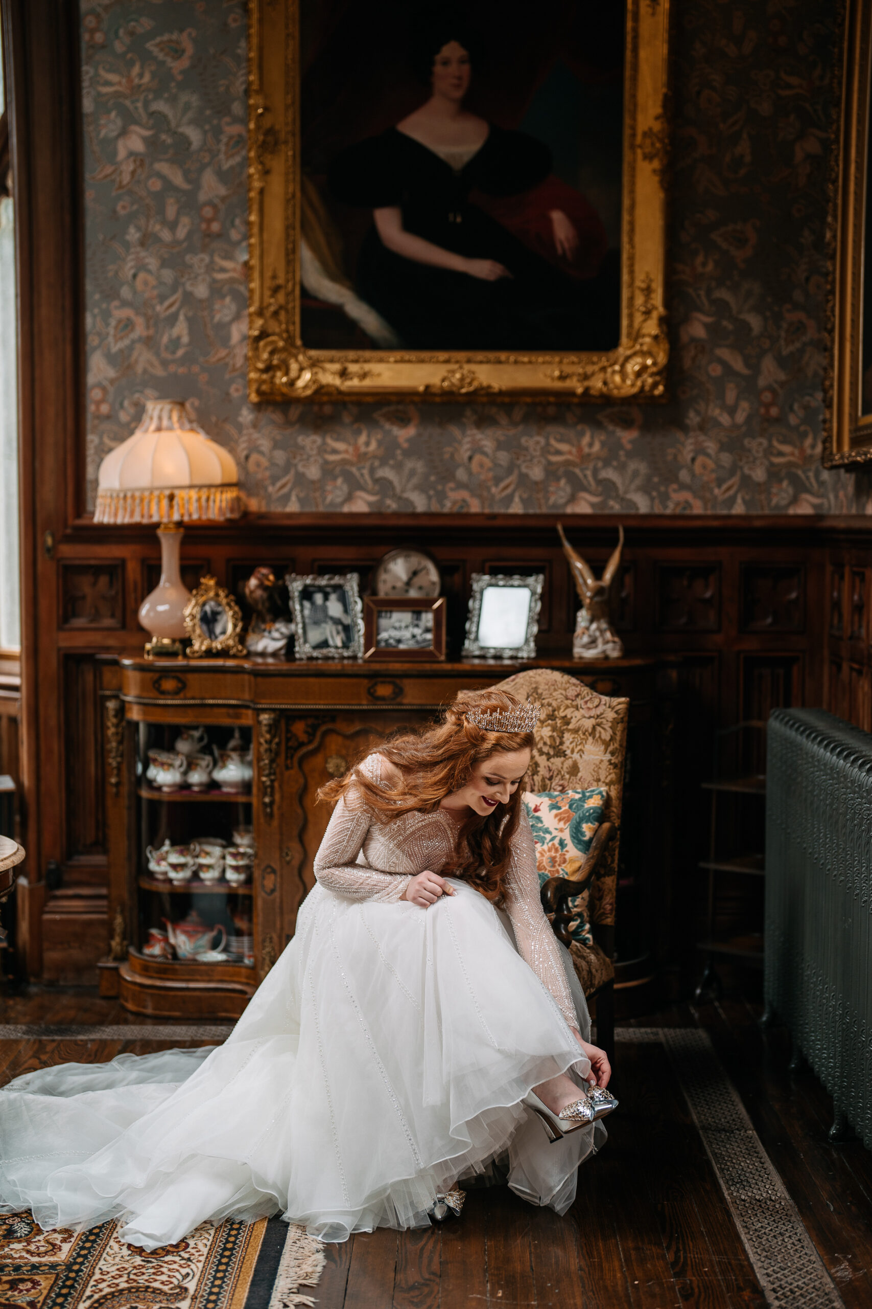 Bride getting ready inside a vintage room at Markree Castle, sitting in antique surroundings.
