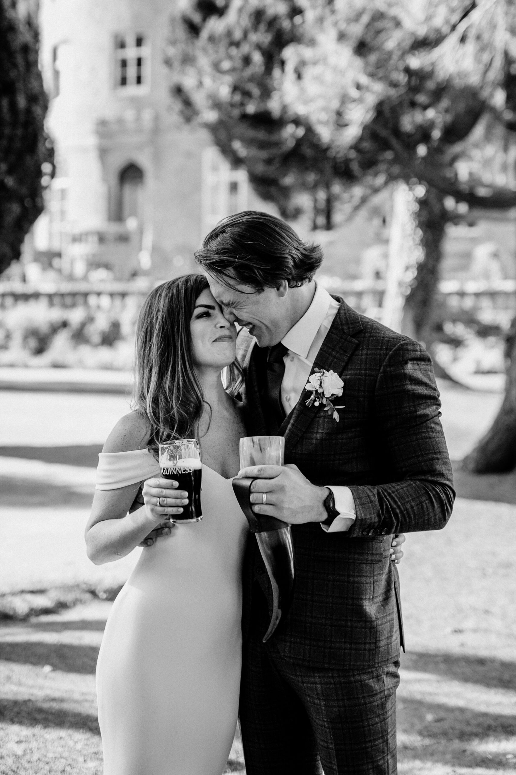 Bride and groom sharing a toast in front of Markree Castle – black and white wedding portrait by a Castle Wedding Photographer Ireland