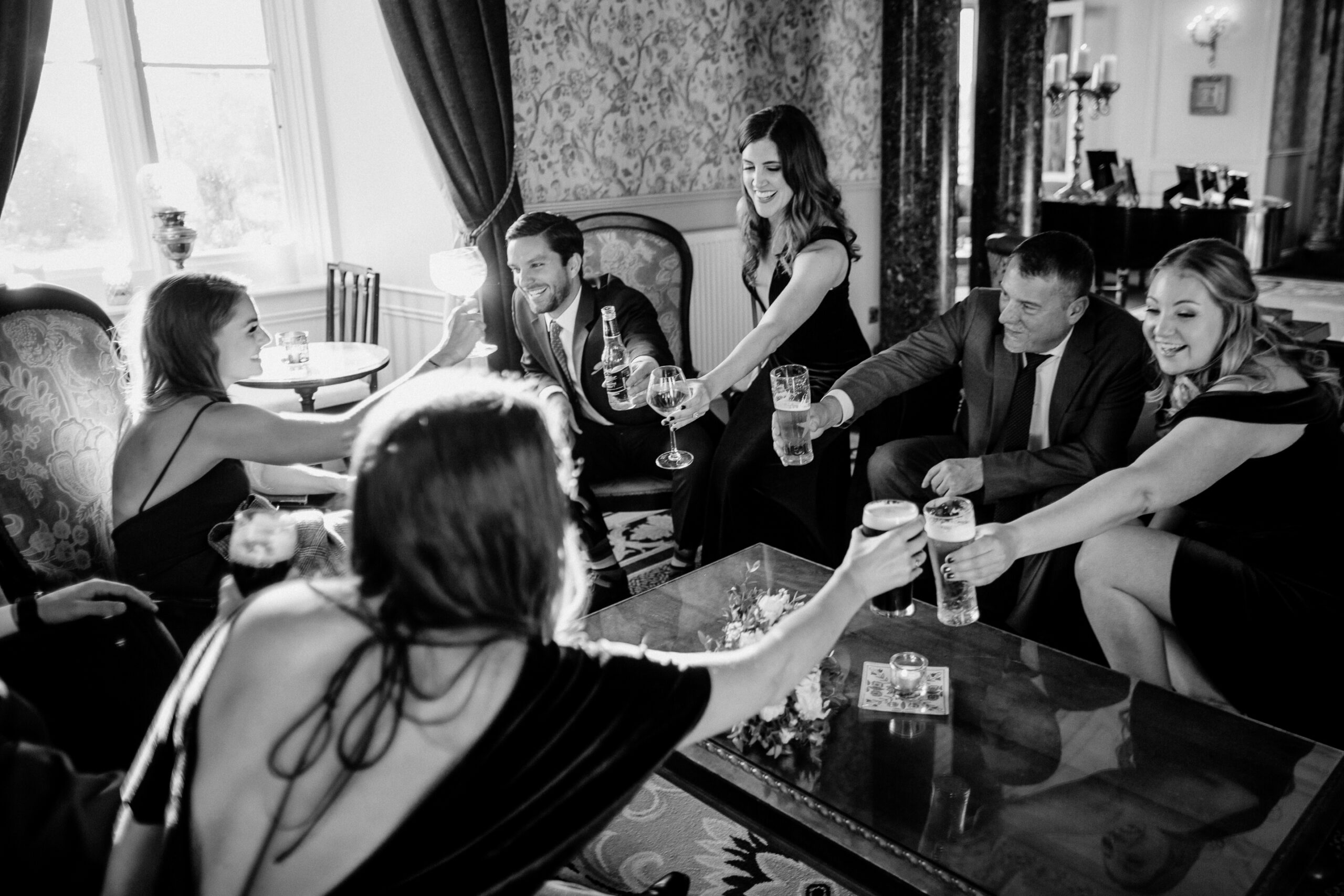 Wedding guests relaxing in the lounge at Markree Castle during the drinks reception