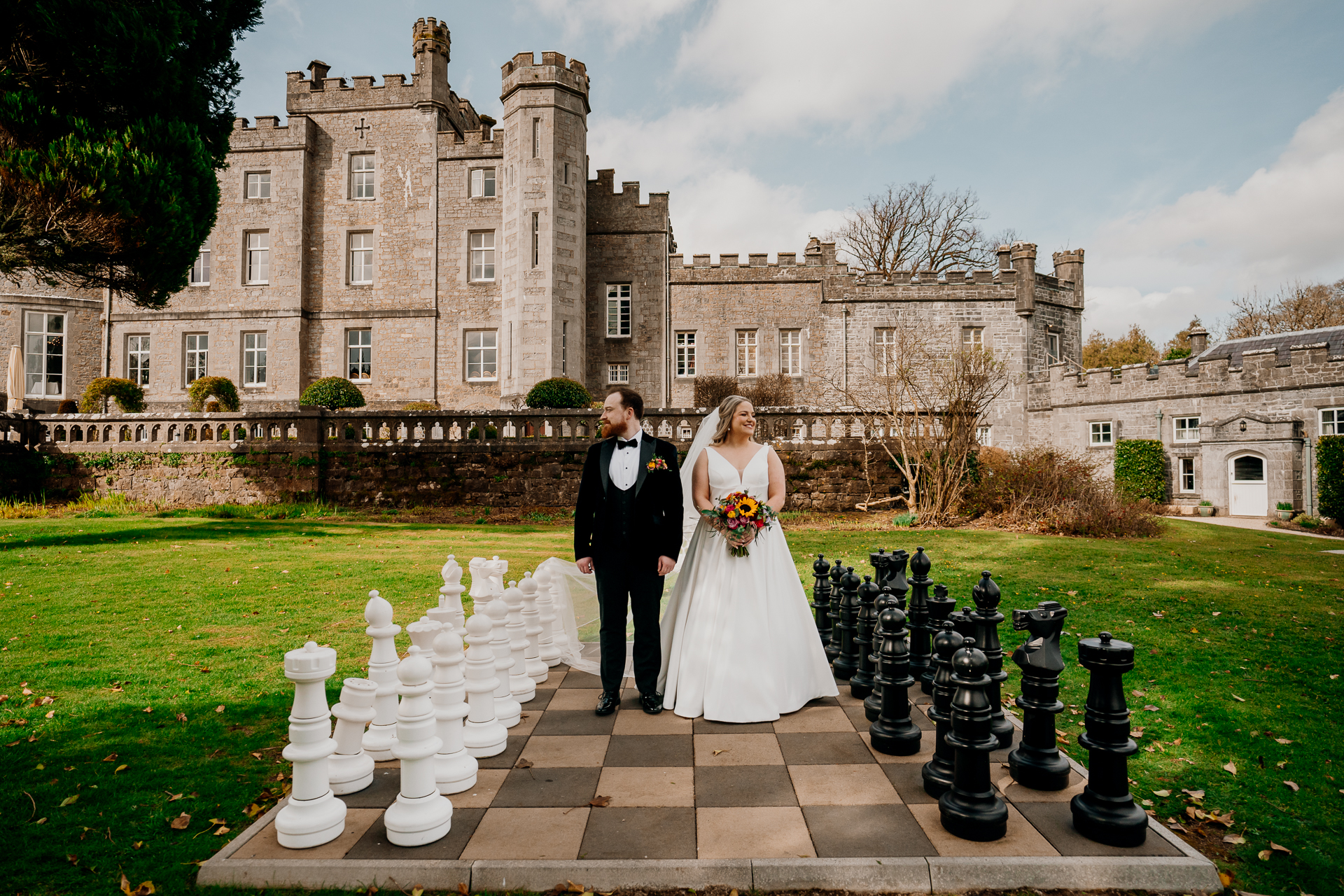 Bride and groom walking in the chess garden at Markree Castle during a summer wedding