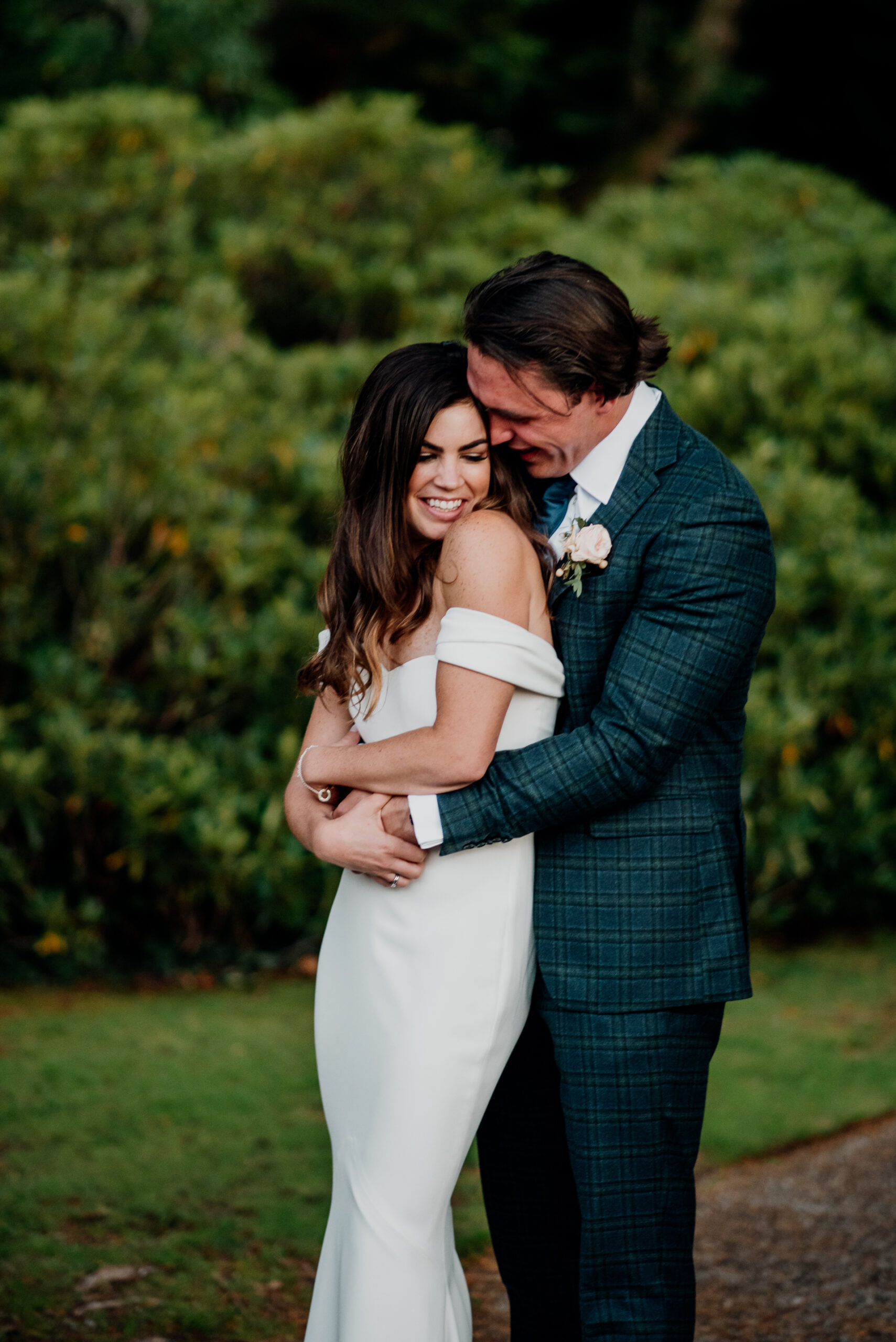 Bride and groom embracing in the garden of Markree Castle – romantic outdoor wedding portrait in Ireland