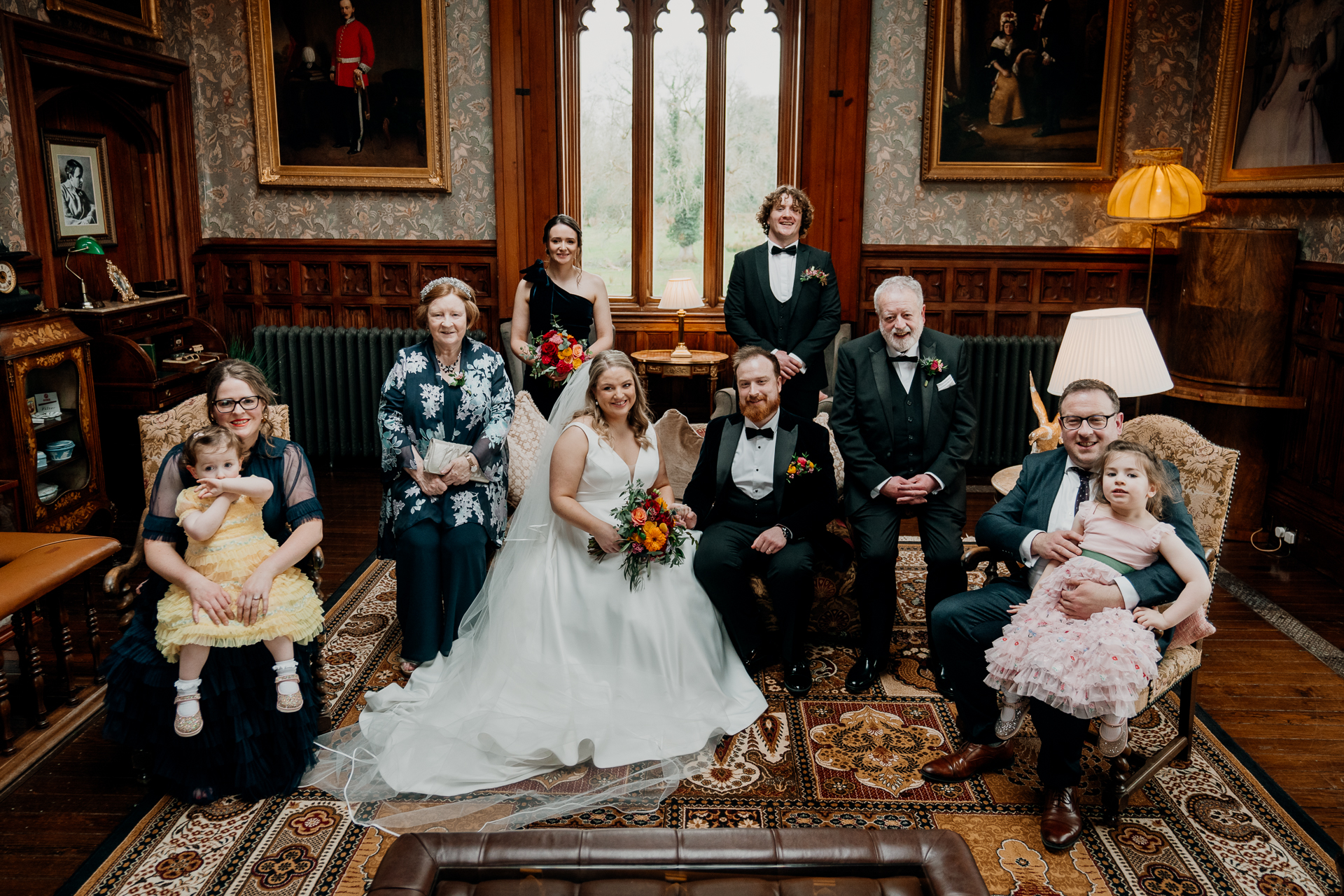 Bride and family sitting for a formal portrait in the Billiard Room at Markree Castle
