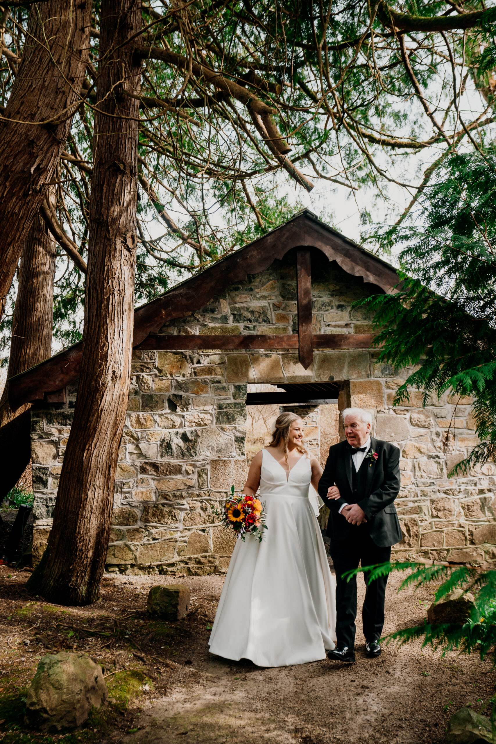 Bride and father walking quietly together near the Boathouse at Markree Castle