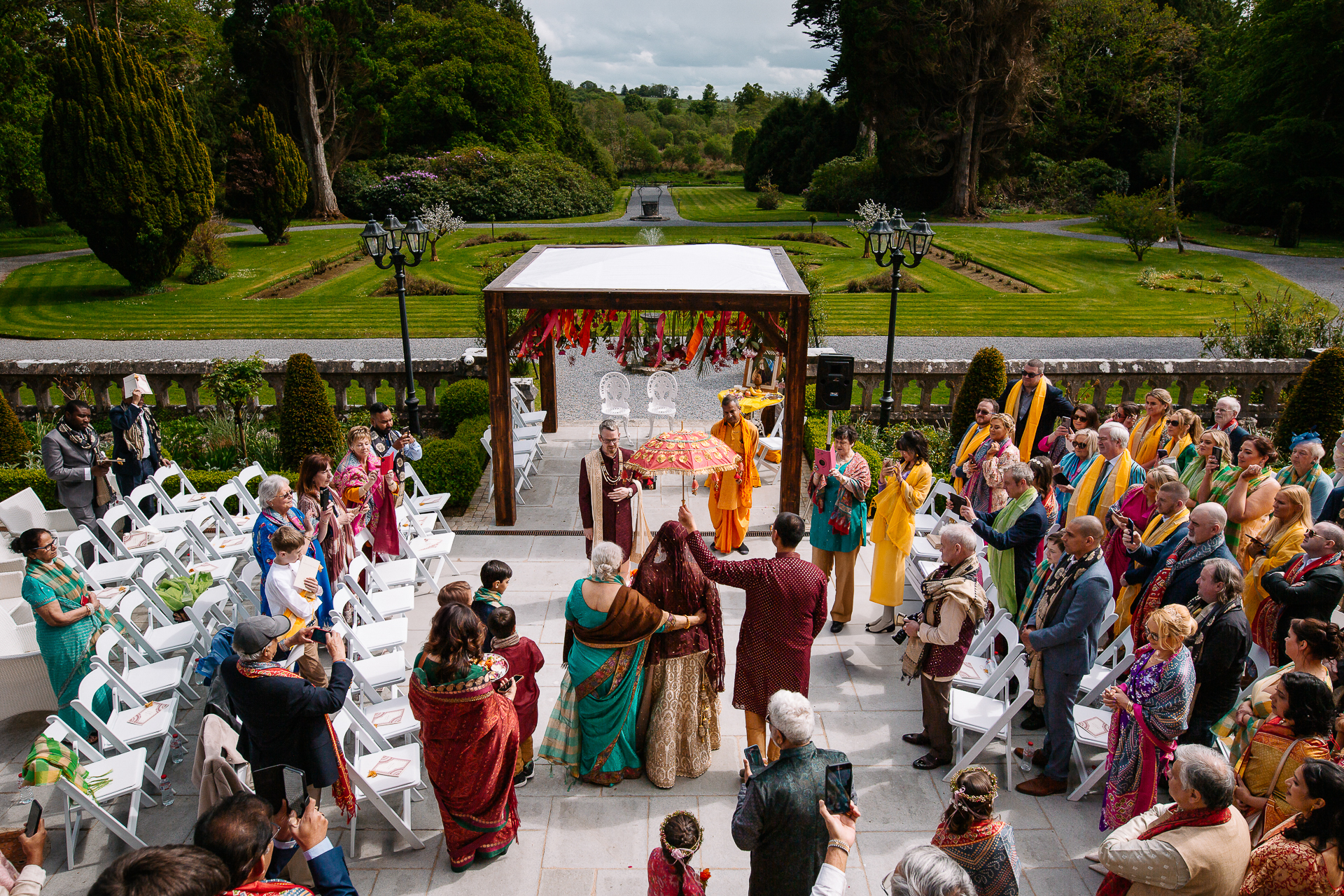 Indian wedding guests attending a colorful garden ceremony at Markree Castle – outdoor rituals under a mandap structure in Ireland