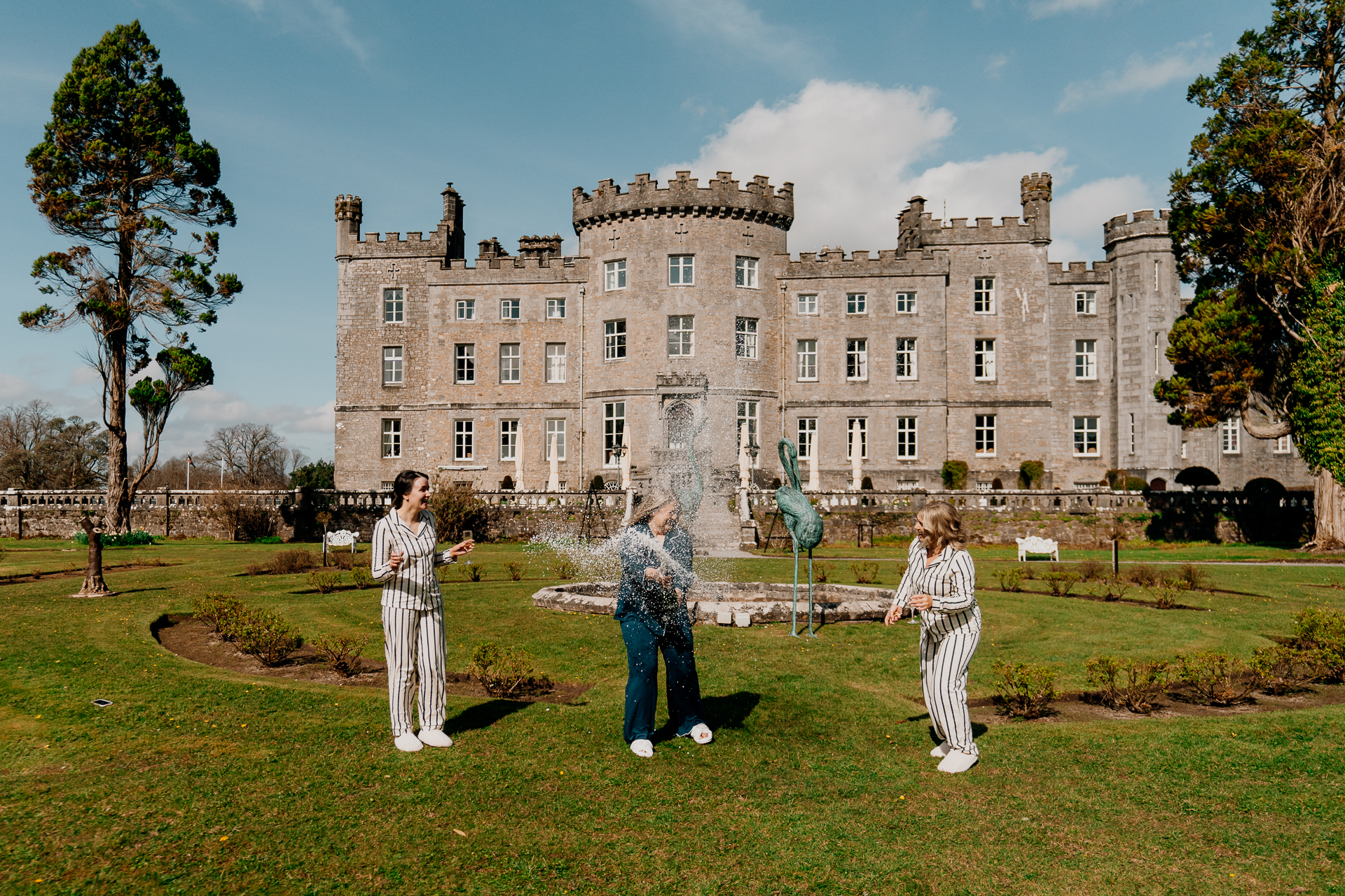Bride and guests toasting with champagne in the garden at Markree Castle during a spring wedding