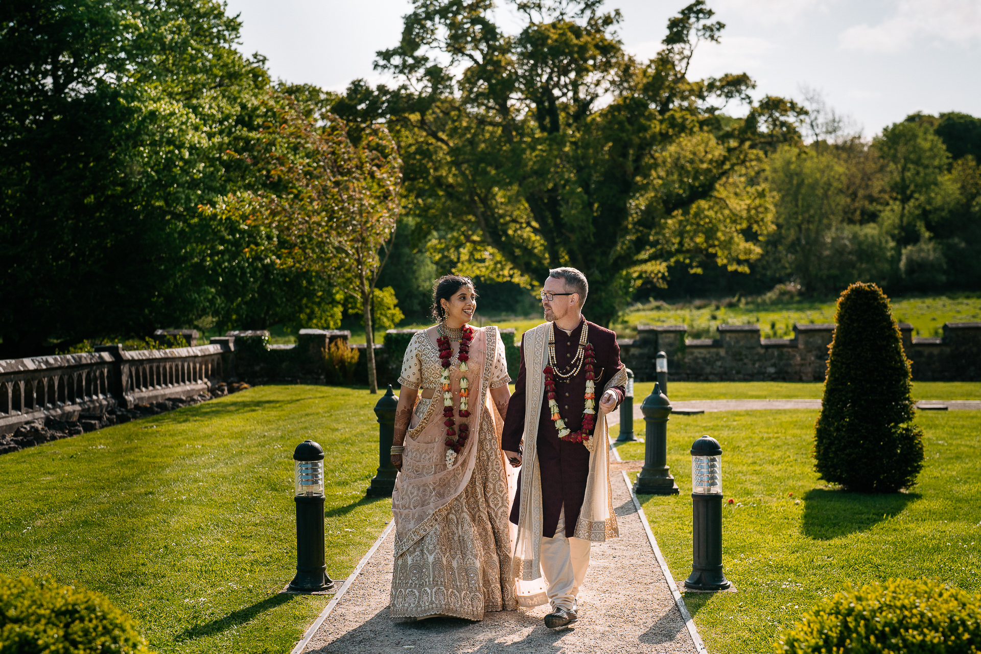 Indian bride and groom walking through the gardens at Markree Castle during their wedding day