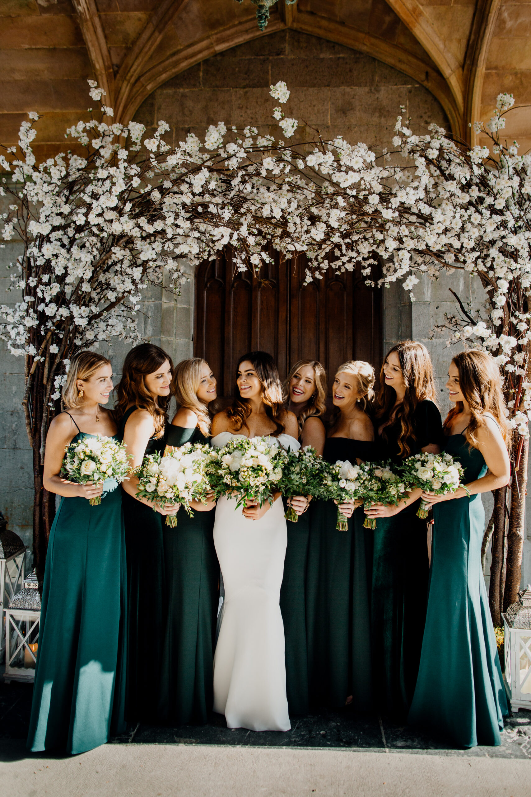 Bridesmaids in green dresses and the bride posing in garden-inspired style at Markree Castle