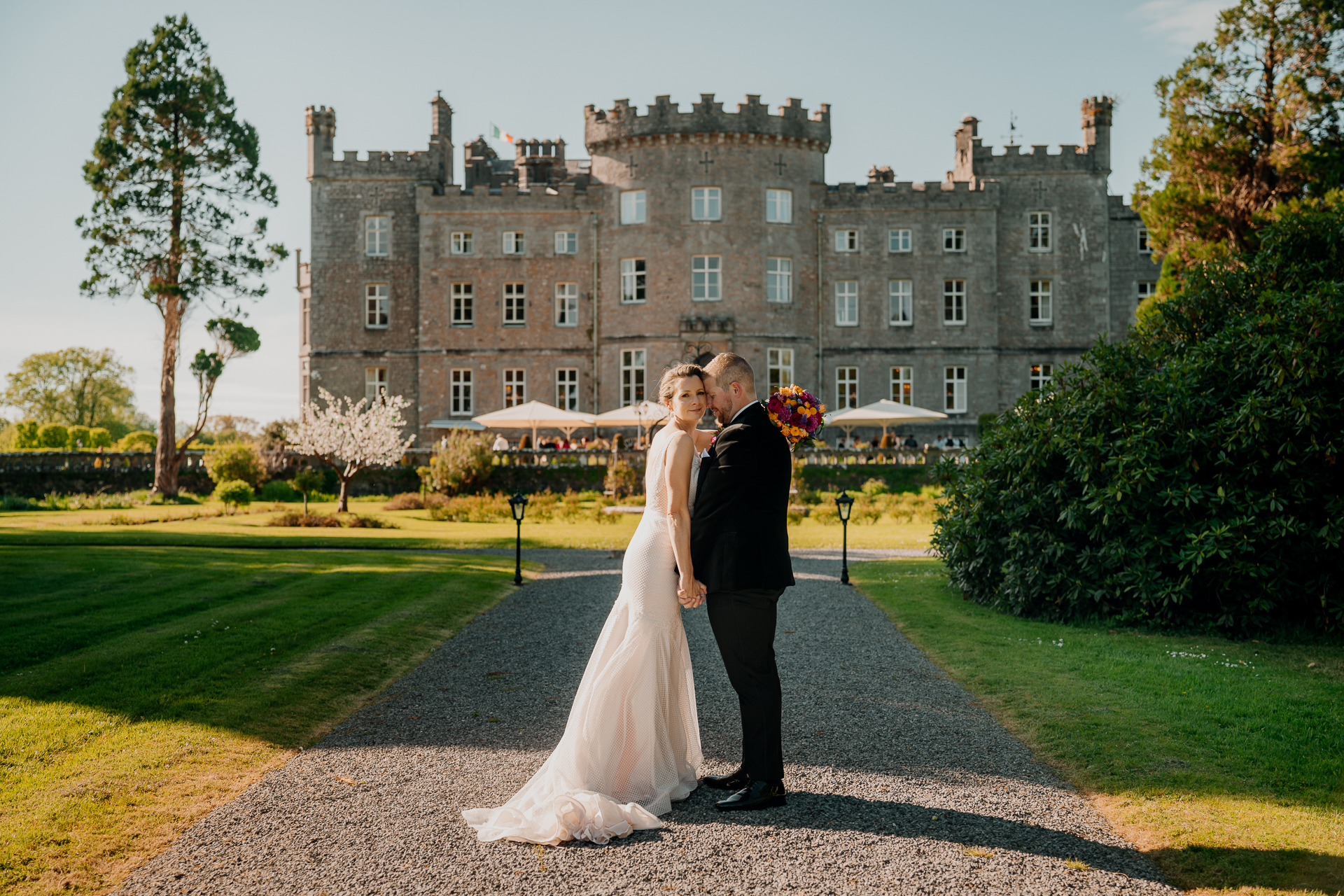 Wedding couple portrait in front of Markree Castle – sunny day with romantic light.