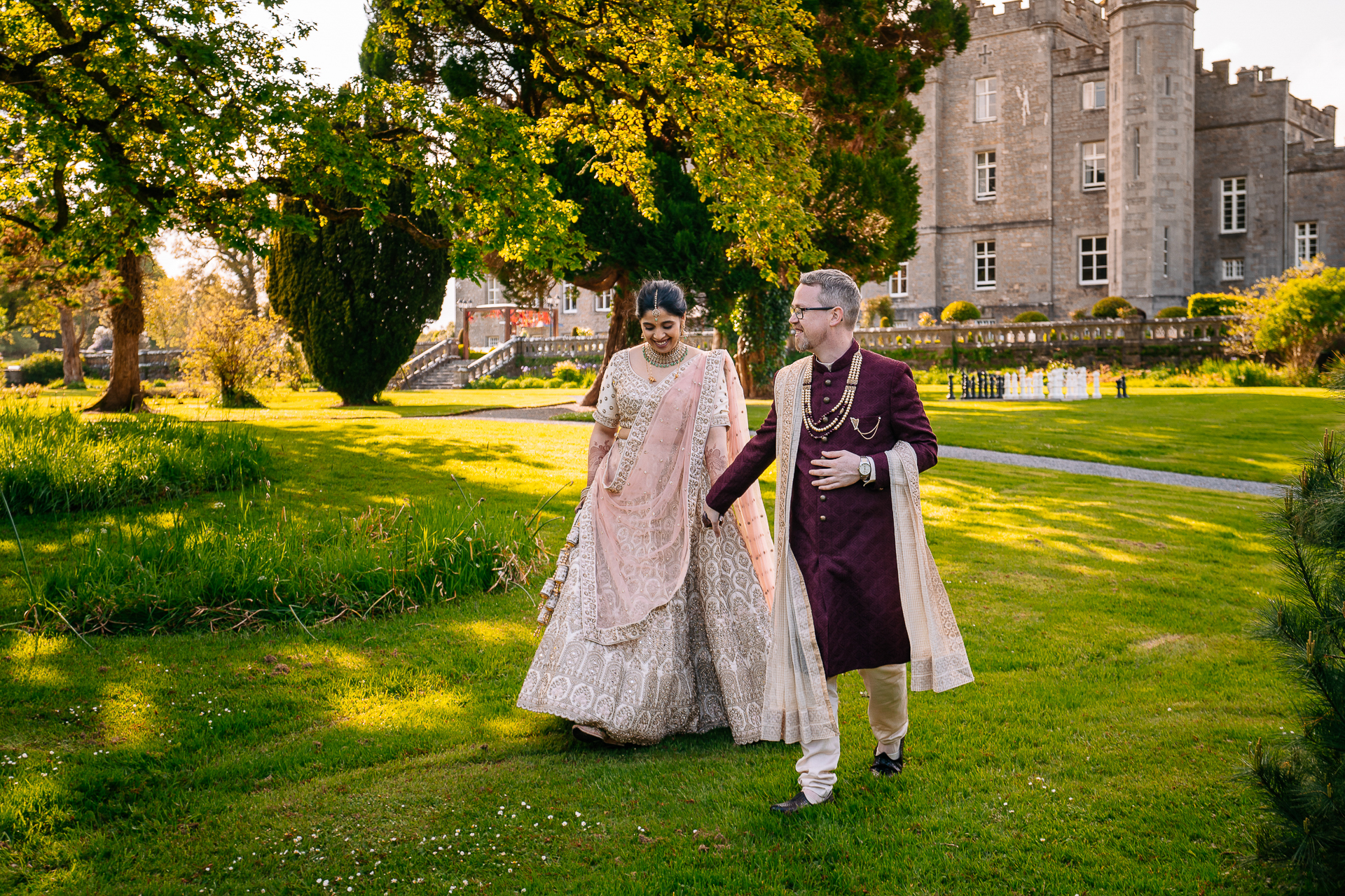 Indian wedding couple walking at sunset in the gardens of Markree Castle