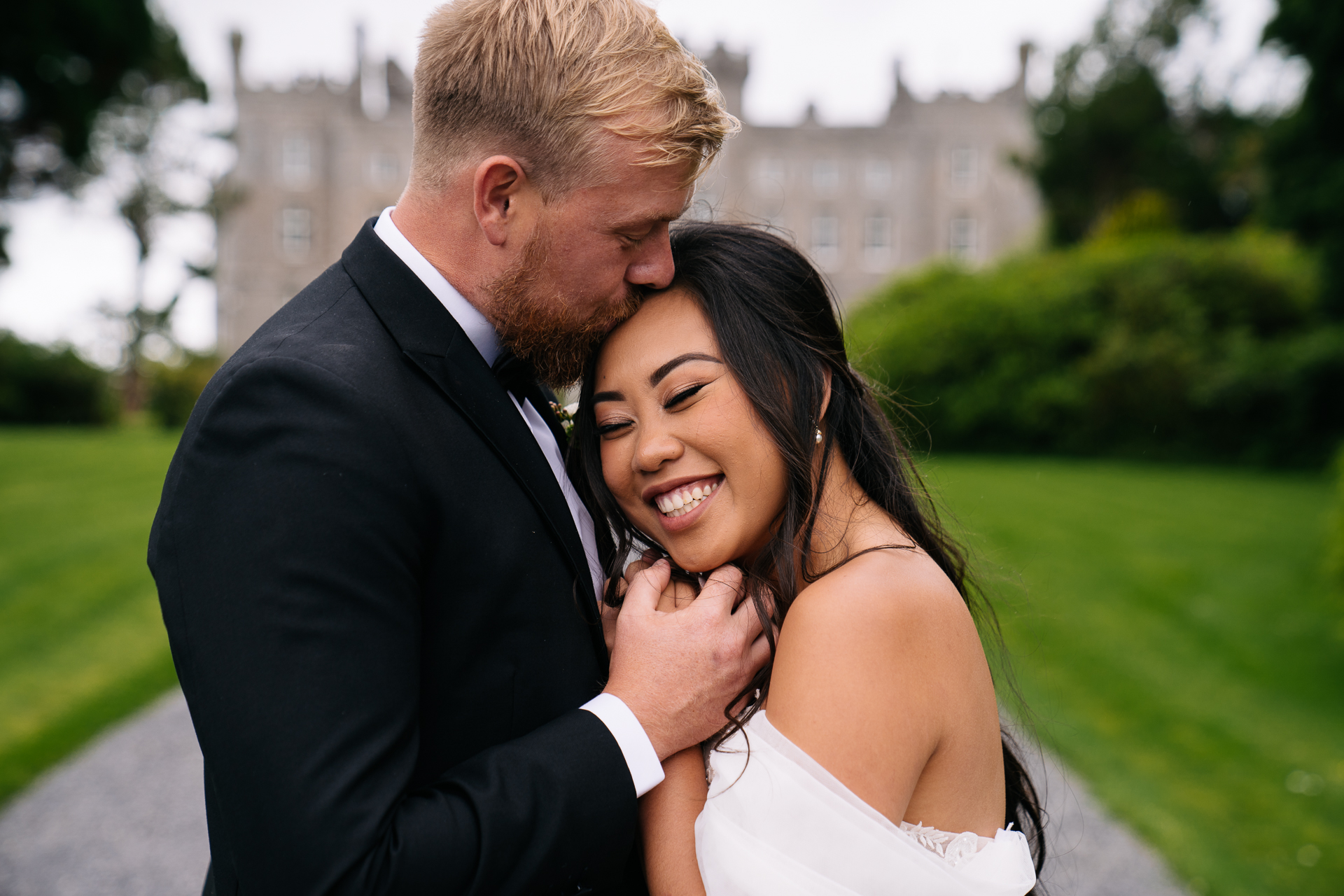 Bride and groom share an intimate embrace in the soft evening light at Markree Castle wedding garden