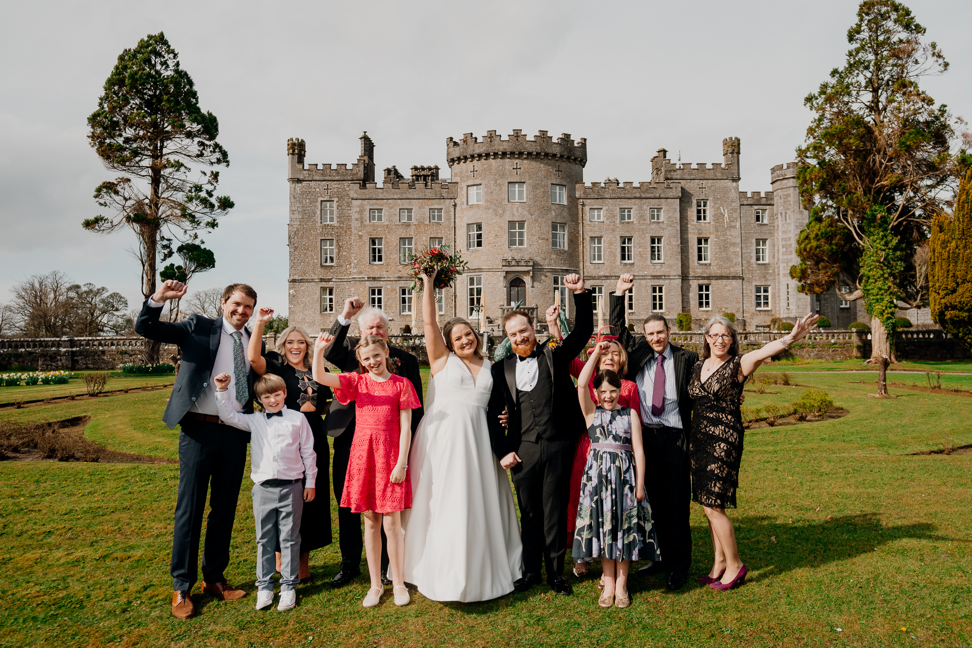 Wedding couple posing with family in the garden at Markree Castle