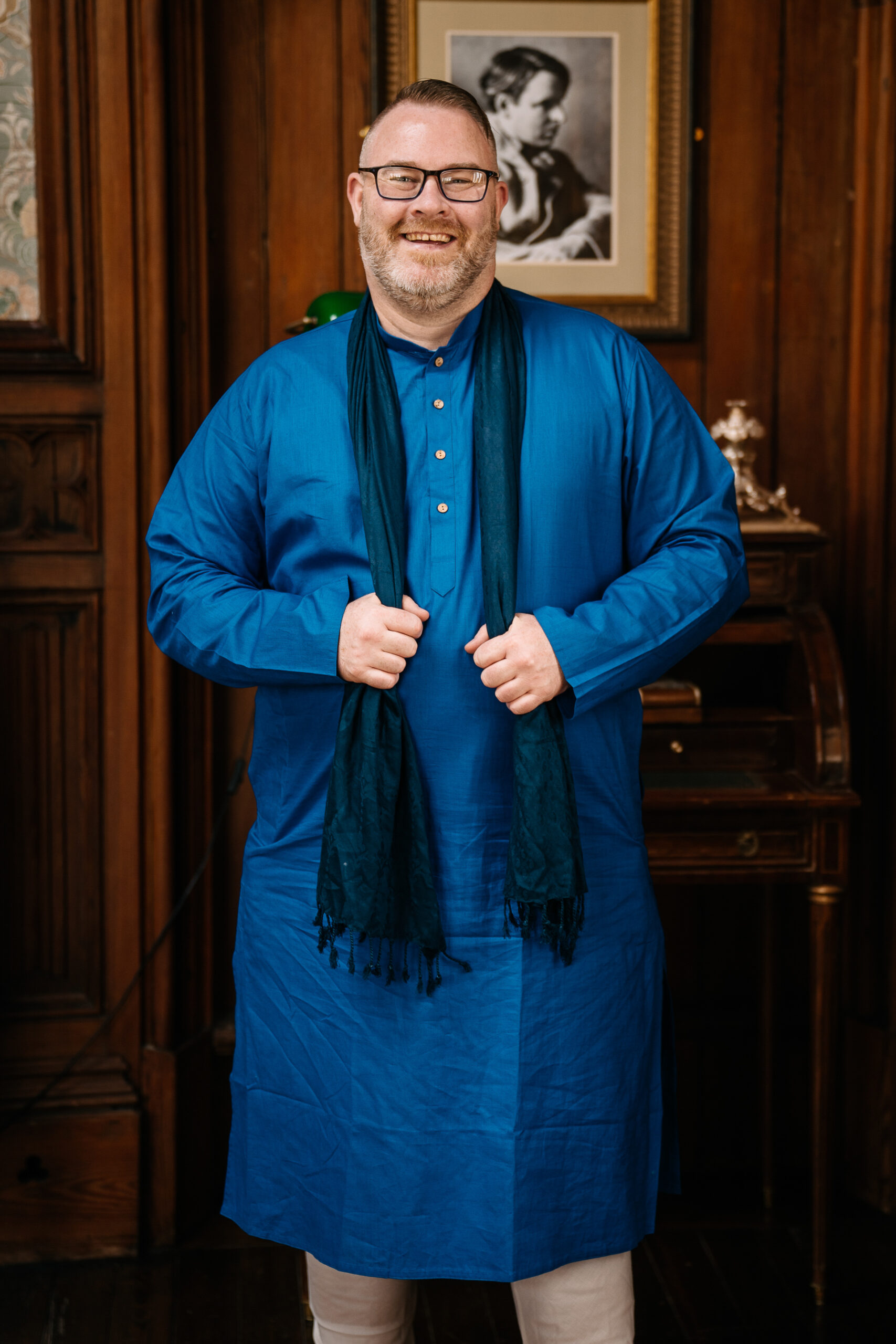 Groomsman smiling in a blue kurta at Markree Castle during Indian wedding preparations