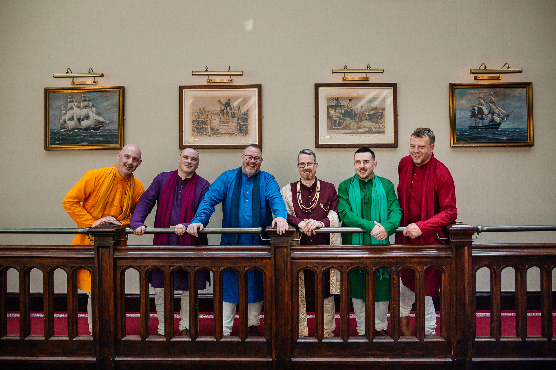 Groomsmen in colorful kurtas posing together on the balcony at Markree Castle wedding