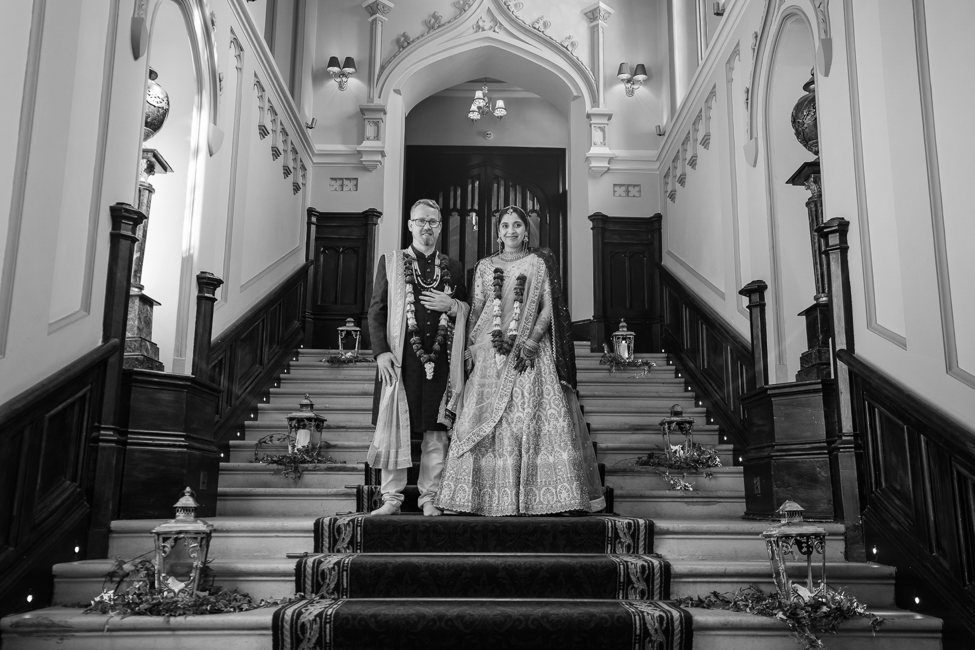 Indian bride and groom standing on the grand staircase of Markree Castle during their destination wedding in Ireland