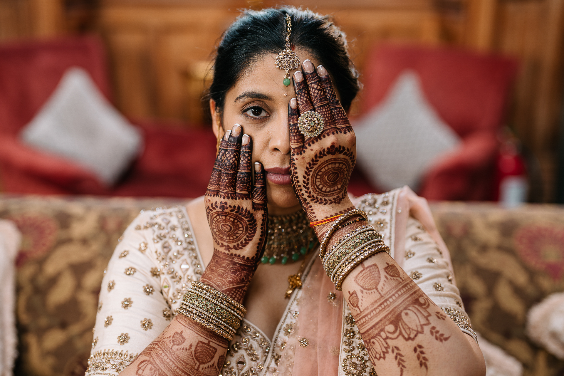 Indian bride showing intricate mehndi designs on her hands during her wedding at Markree Castle