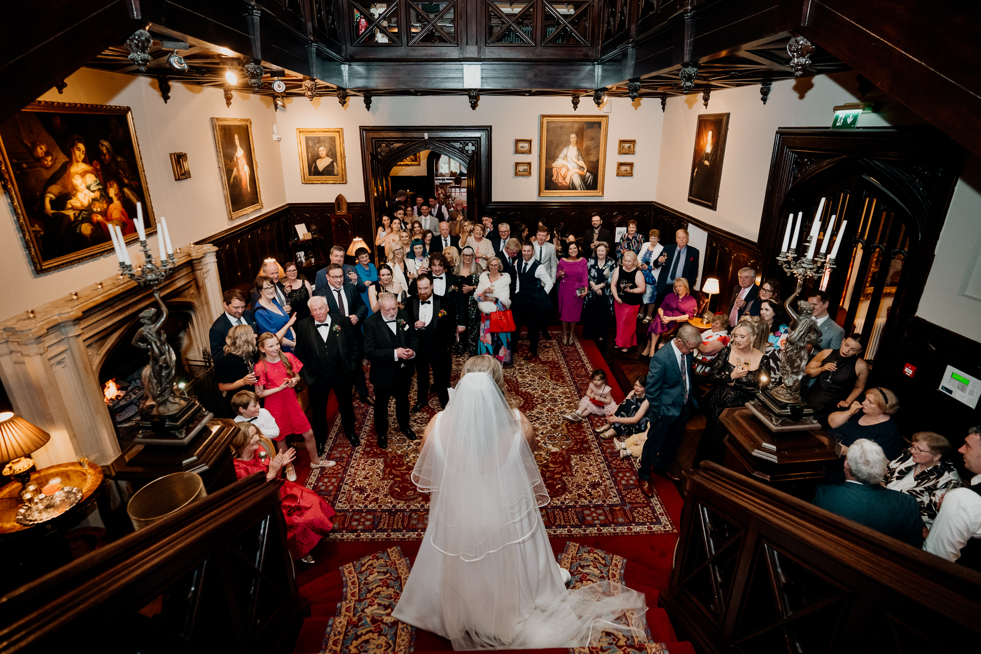 Wedding reception speech at Markree Castle – view from above with bride and guests gathered on the grand staircase