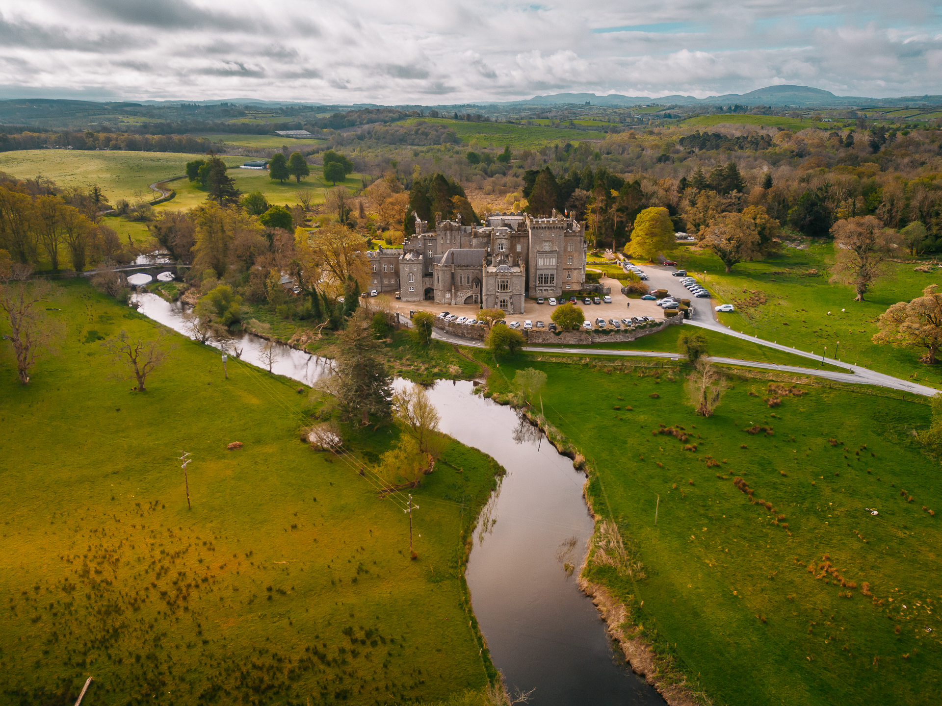 Aerial view of Markree Castle surrounded by green landscape and river in Sligo, Ireland – perfect for elopements and luxury weddings.