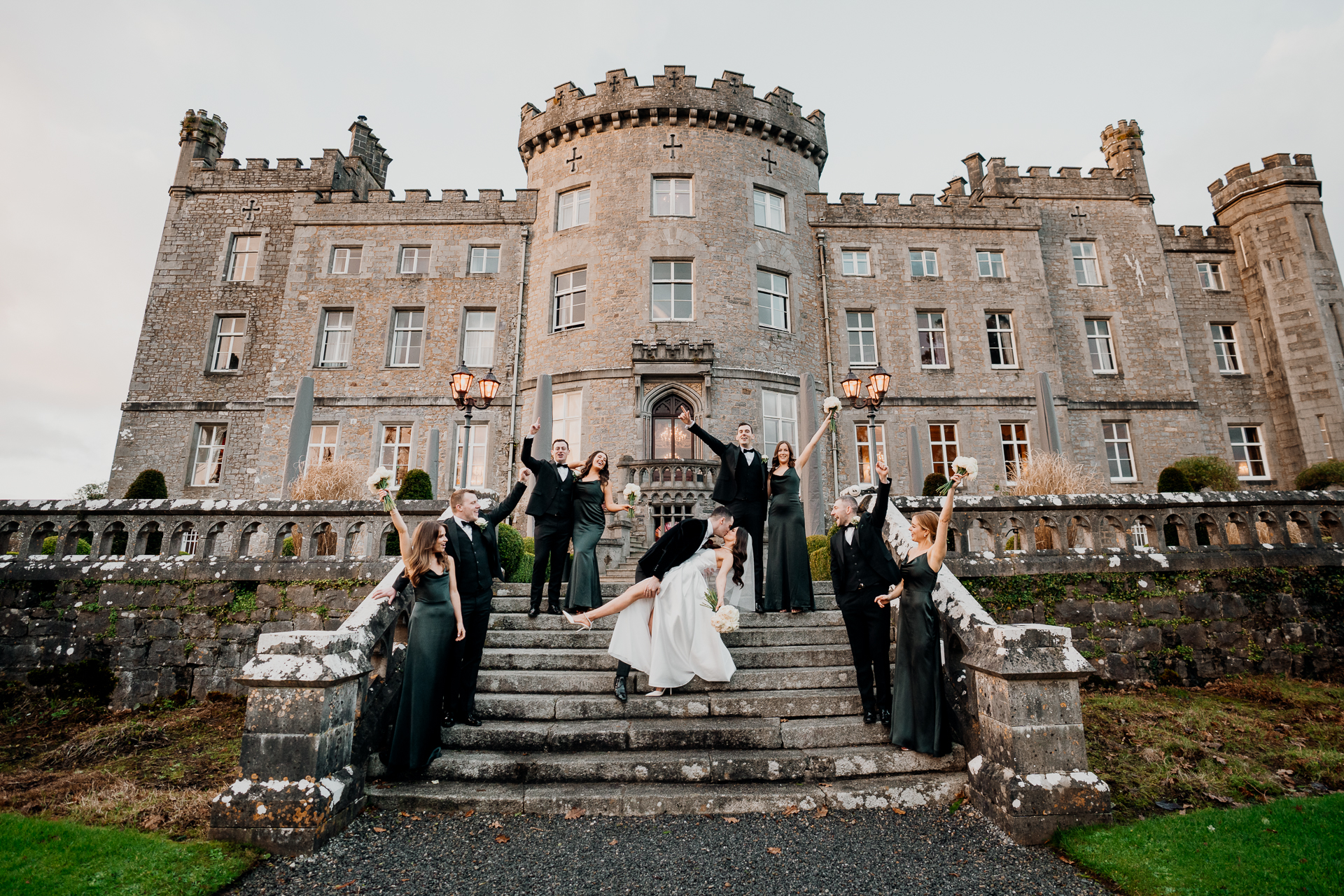 Bridal party celebrating on the steps of Markree Castle during a garden wedding in Sligo, Ireland