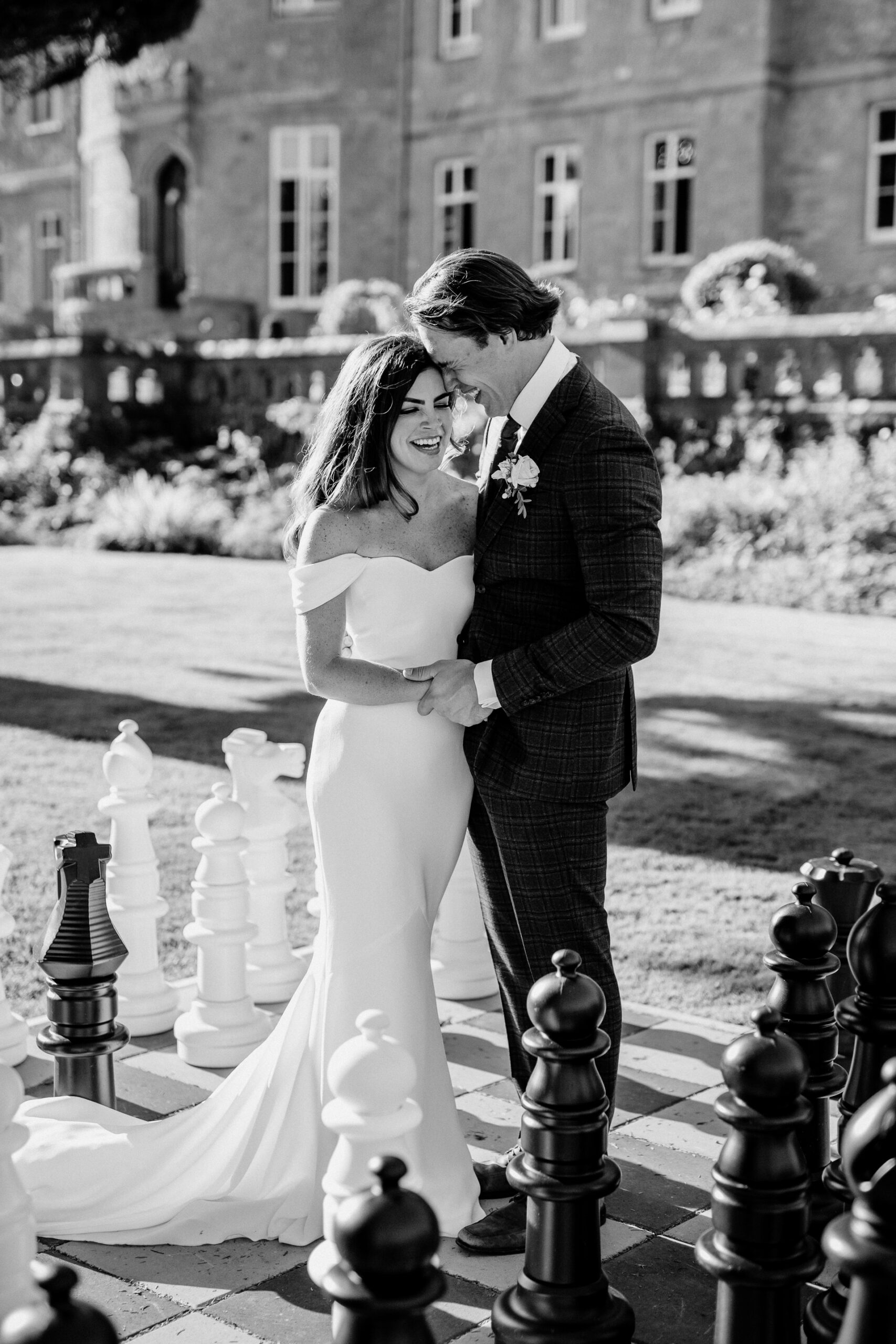 Bride and groom kissing in front of Markree Castle during a romantic wedding portrait