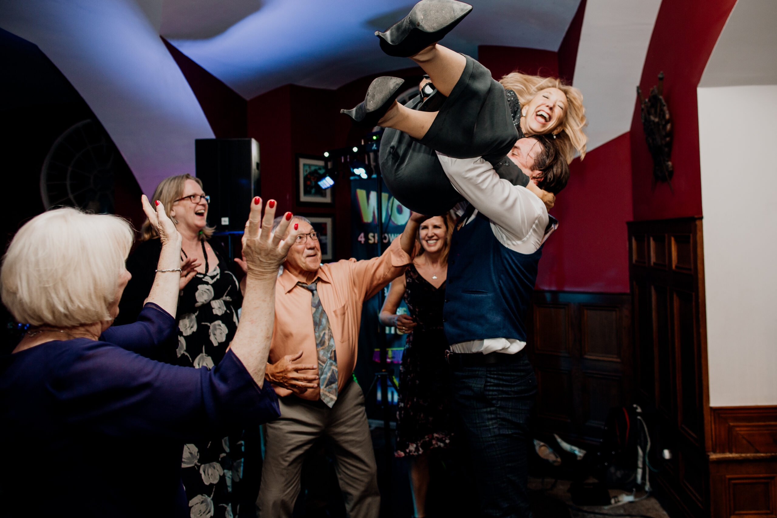 Bride being lifted in the air by wedding guests on the dancefloor at Markree Castle