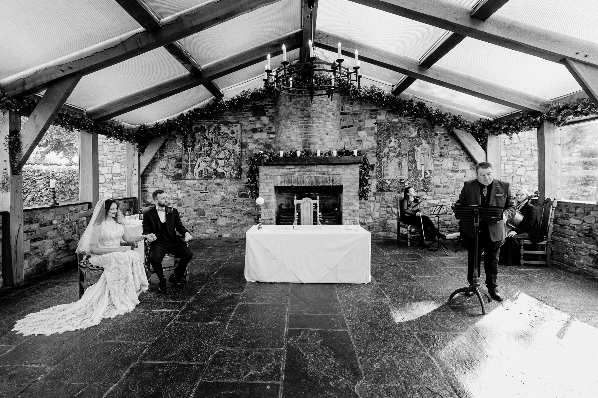 ALT TEXT: A bride and groom during their intimate wedding ceremony inside the stone orangery at Barberstown Castle – captured by a Dublin Wedding Photographer.