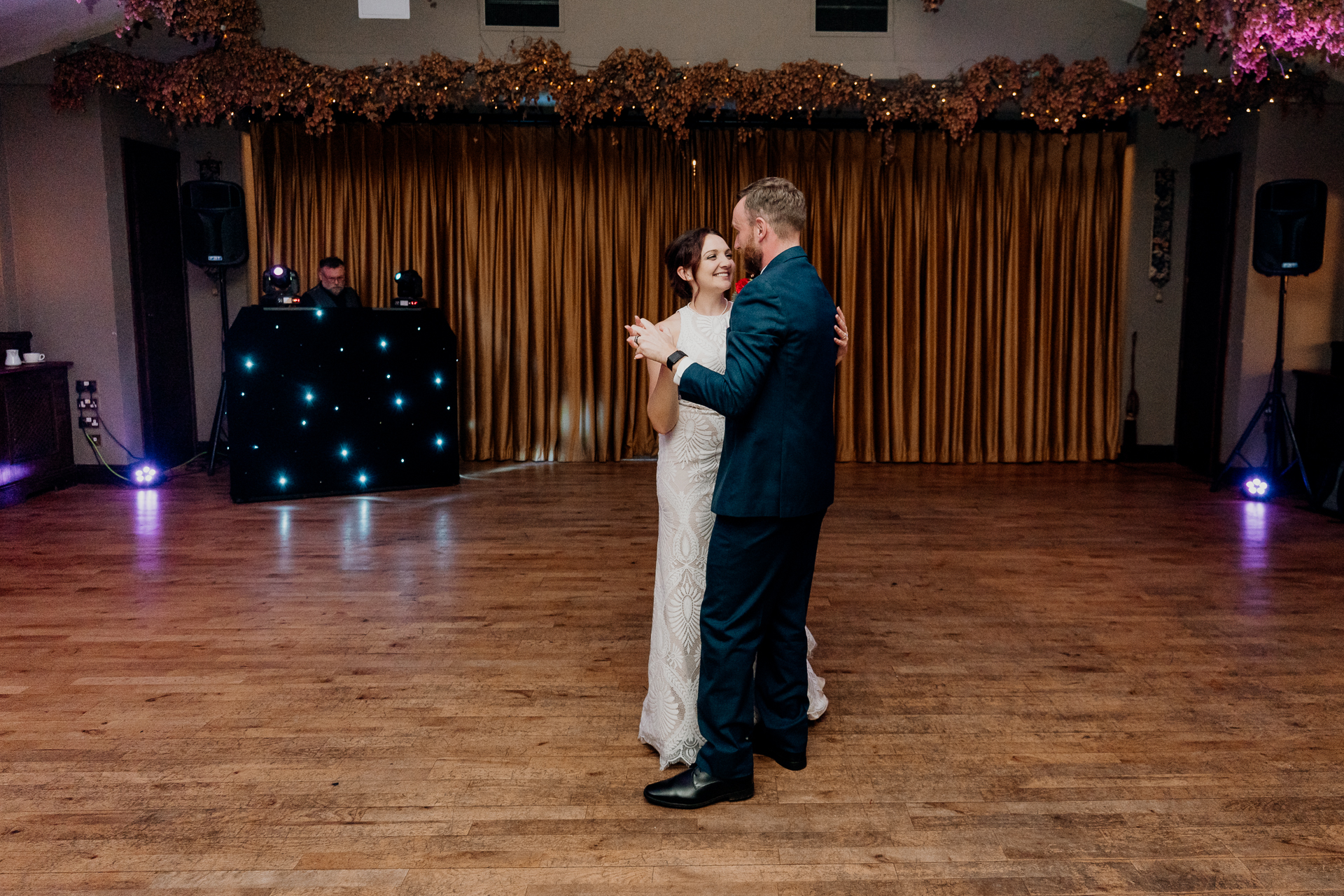 Bride and groom share their first dance at Barberstown Castle in an intimate and warmly lit reception room.