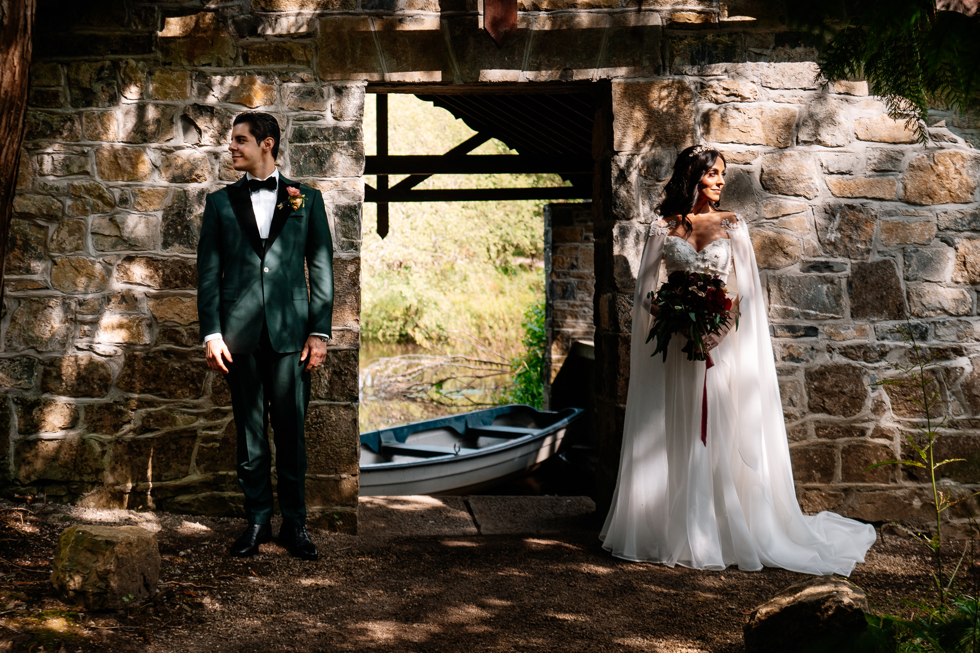 Bride and groom standing at the Boathouse entrance at Markree Castle, with rustic stone walls and romantic backlight

