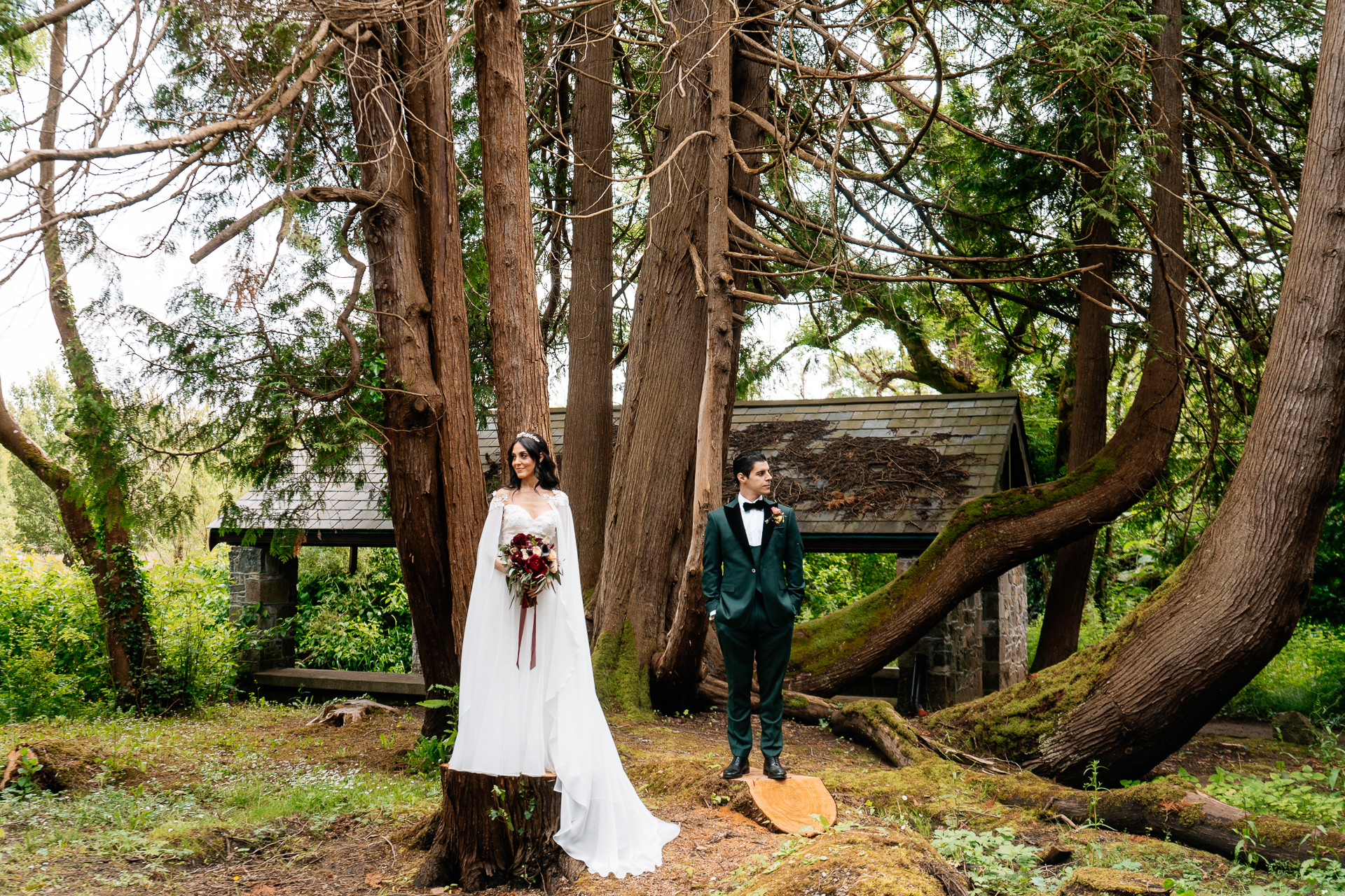 Bride and groom posing in a forest near the Boathouse at Markree Castle during their wedding photo session

