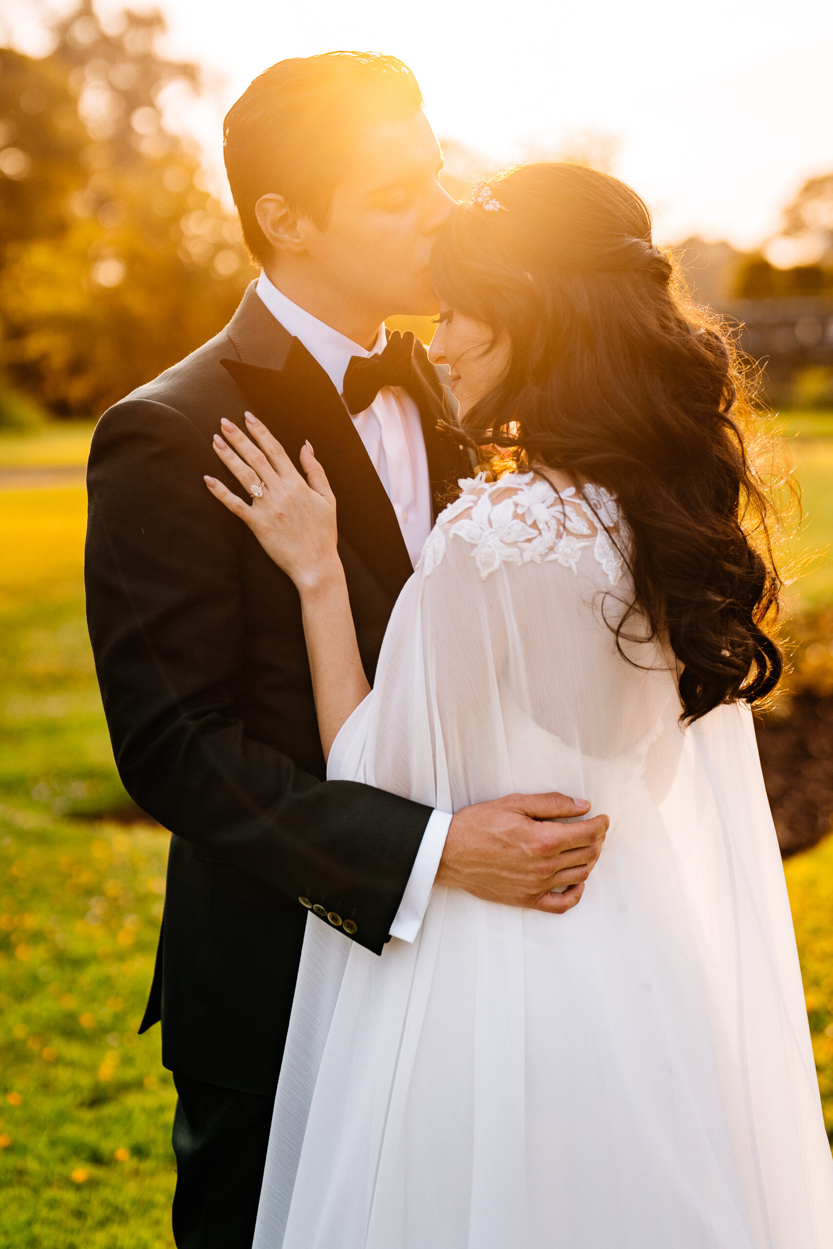 Bride and groom kissing during golden hour in front of Markree Castle

