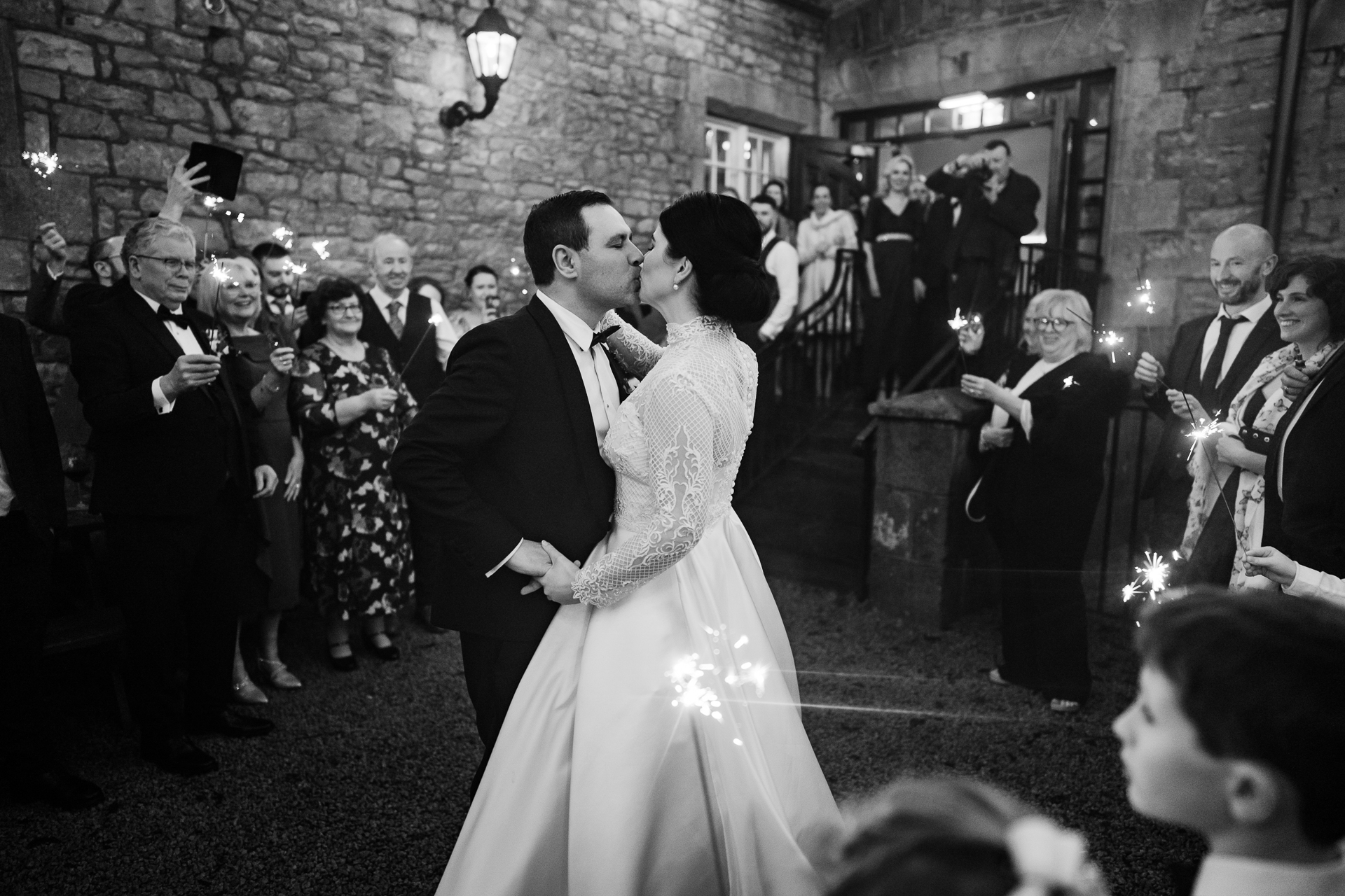 Bride and groom kissing during a sparkler first dance in Markree Castle Courtyard