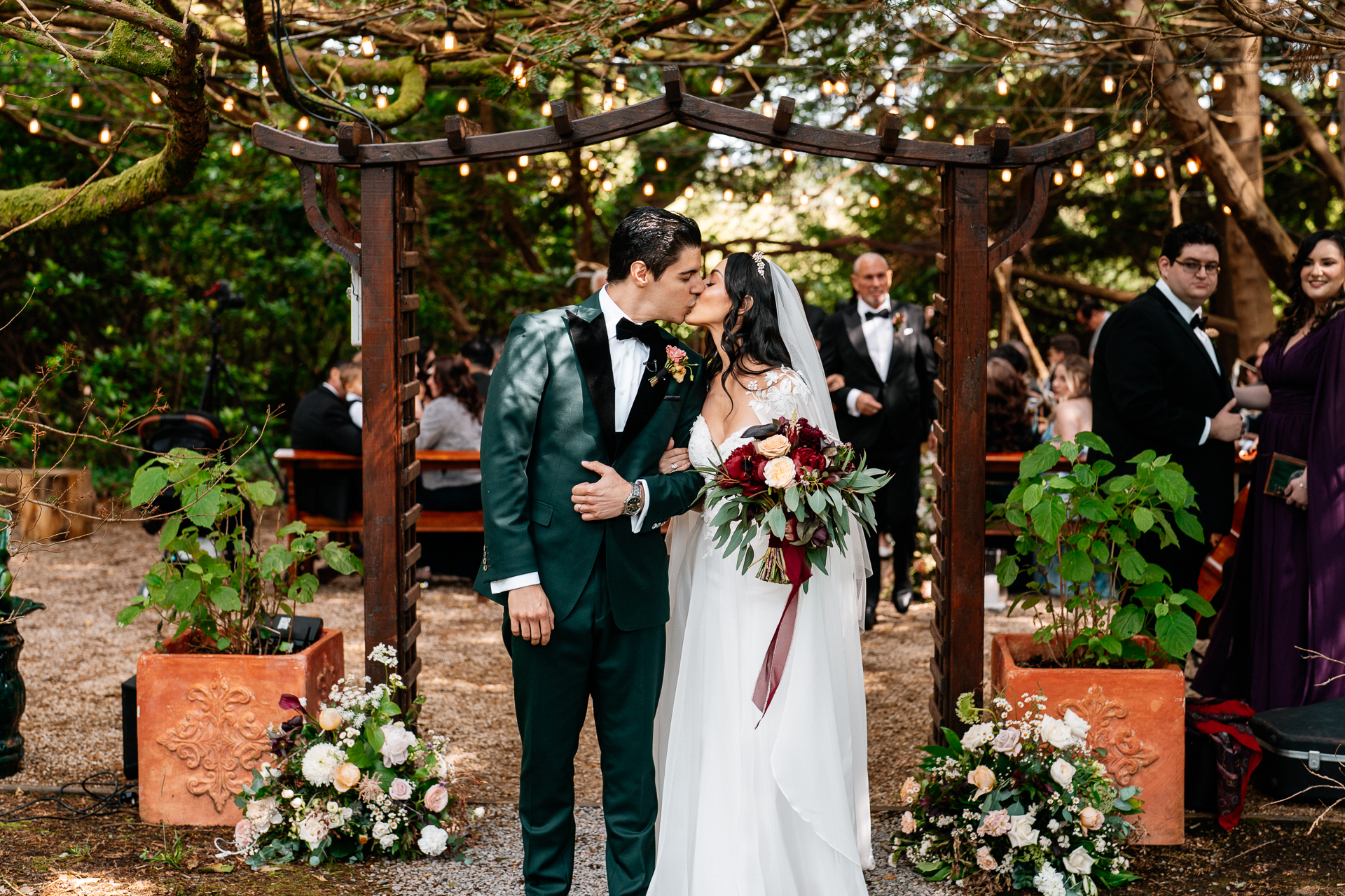 Bride and groom sharing their first kiss after garden wedding ceremony at Markree Castle

