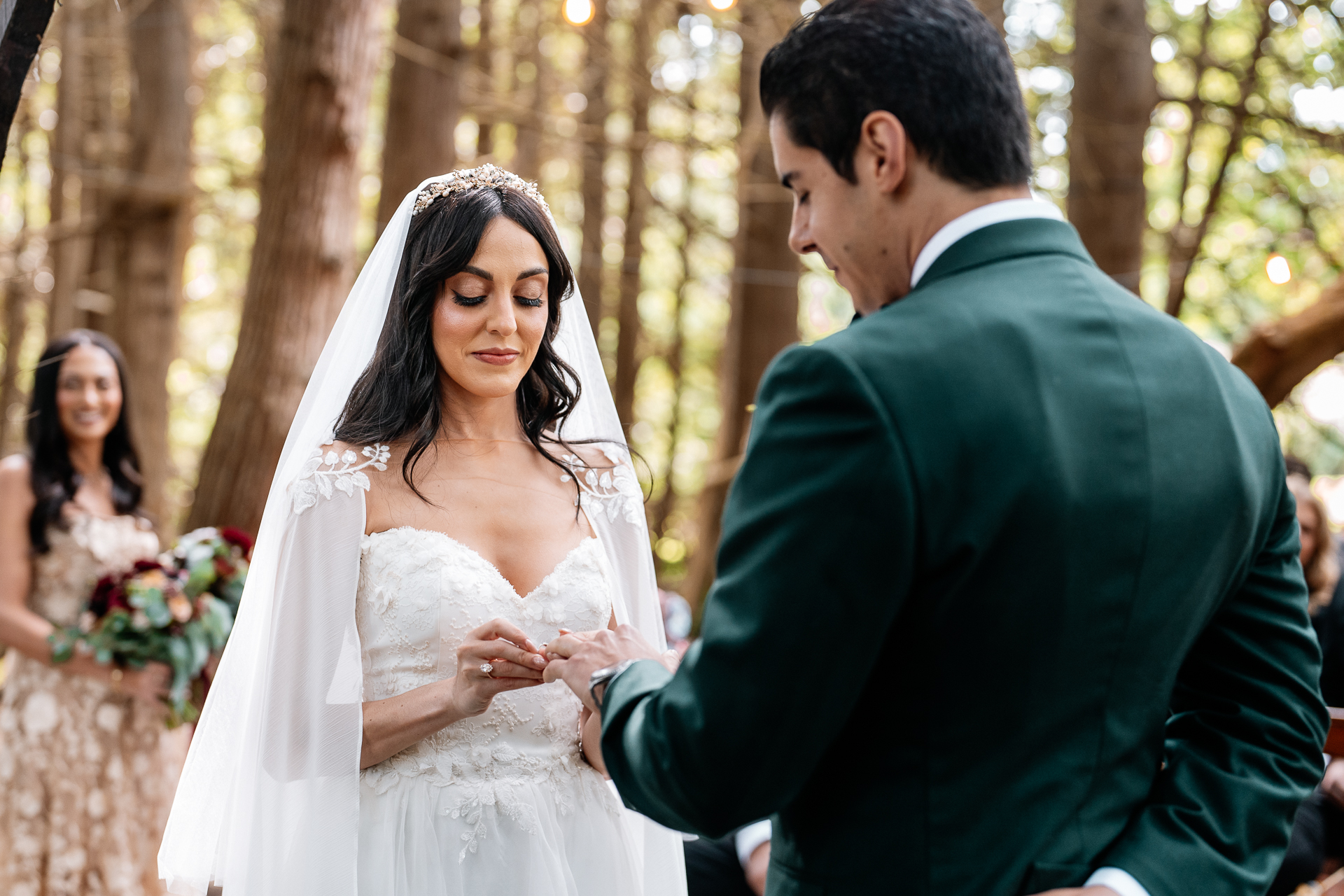 Bride placing ring on groom’s finger during garden ceremony at Markree Castle

