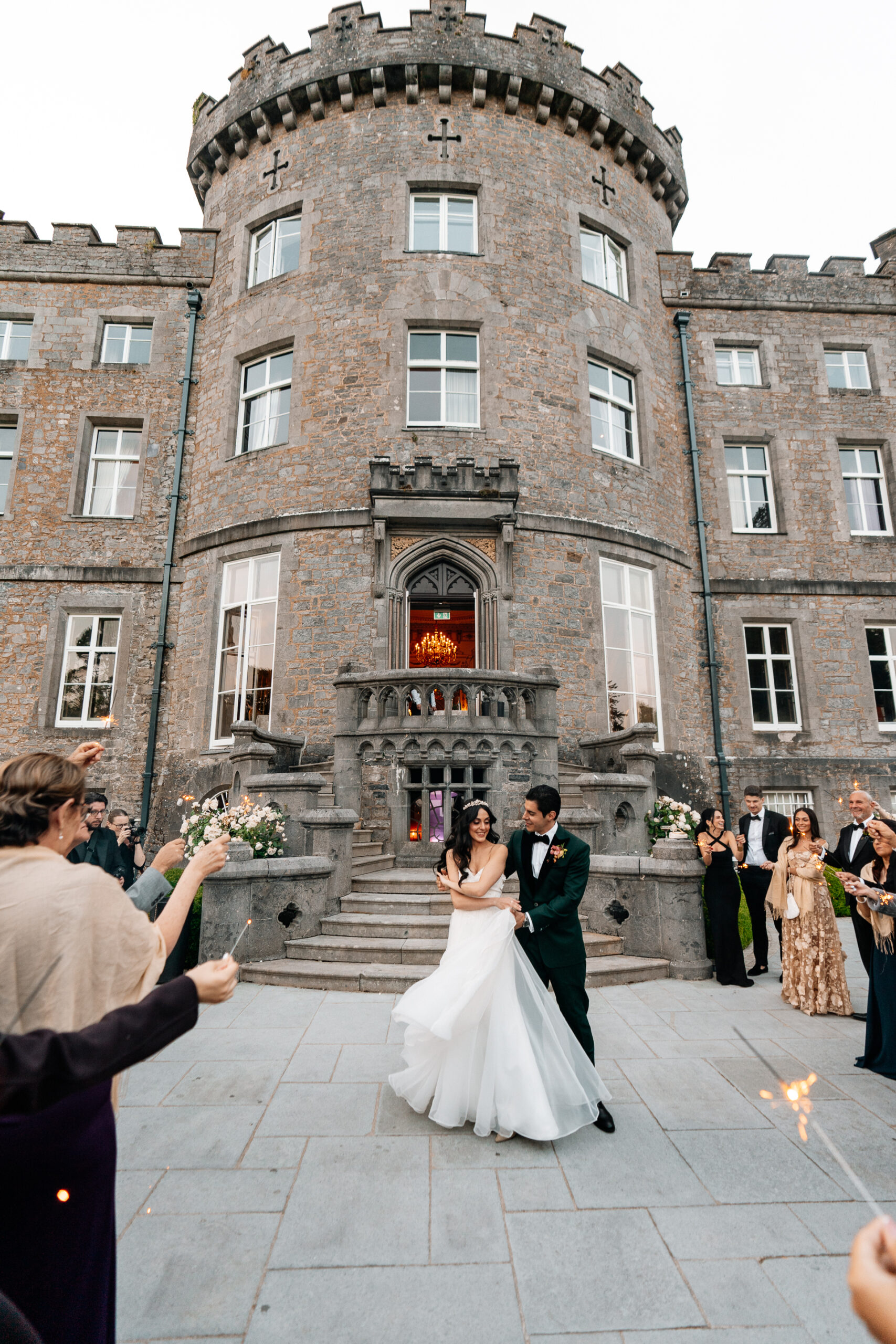 Bride and groom sharing their first dance on the garden terrace of Markree Castle under twinkling lights