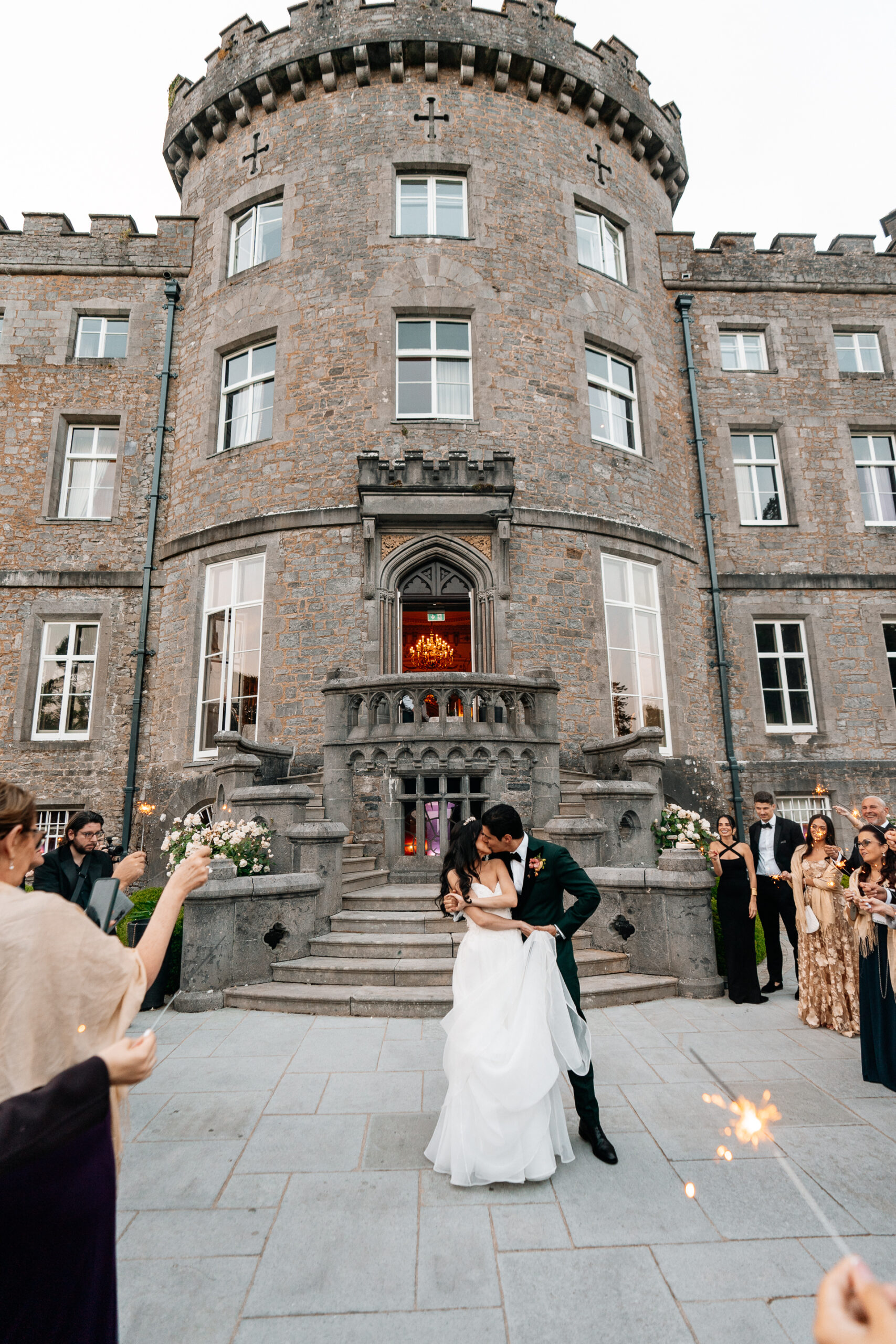 Bride and groom sharing their first dance on the garden terrace of Markree Castle under twinkling lights