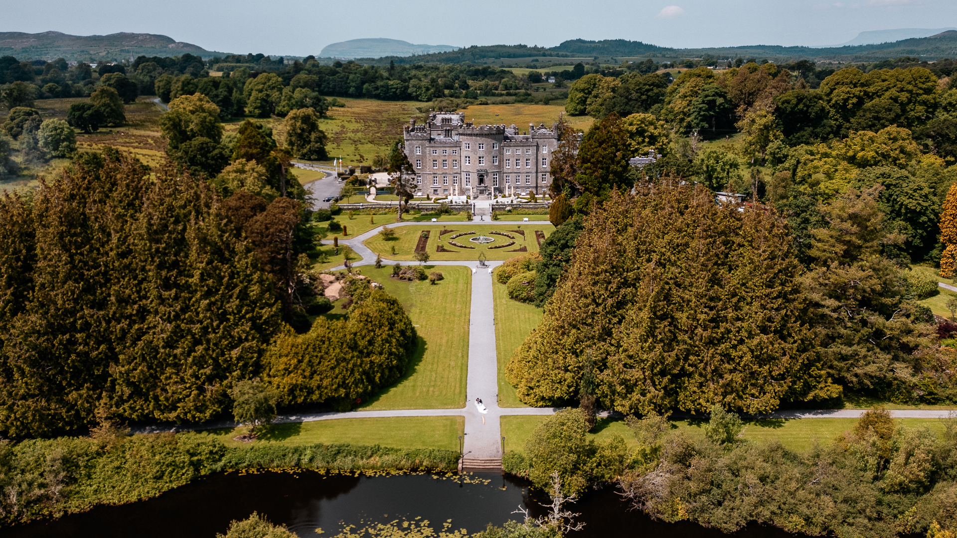 Bride and groom seeing each other for the first time during a first look by the river at Markree Castle