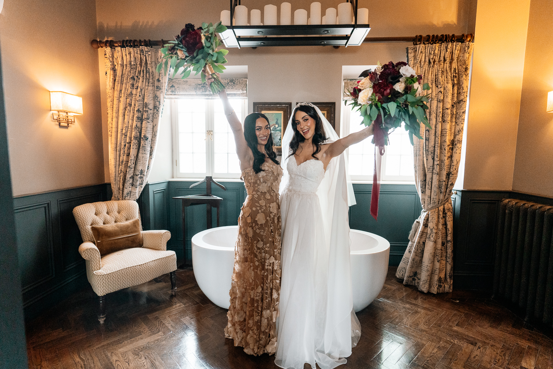 Bride and bridesmaid posing together for a portrait in the bridal suite at Markree Castle