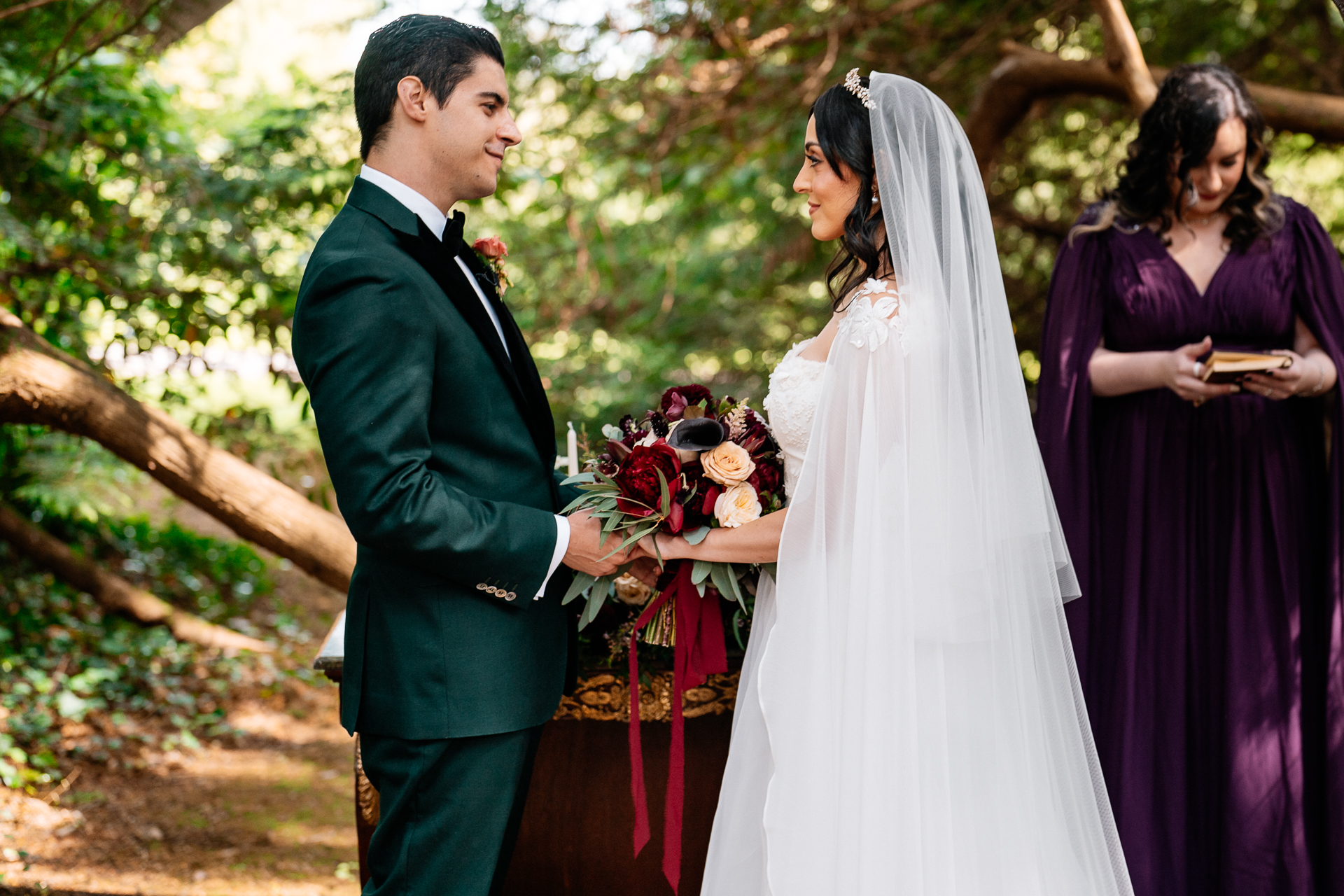 Bride and groom exchanging vows during a woodland ceremony in the forest clearing at Markree Castle