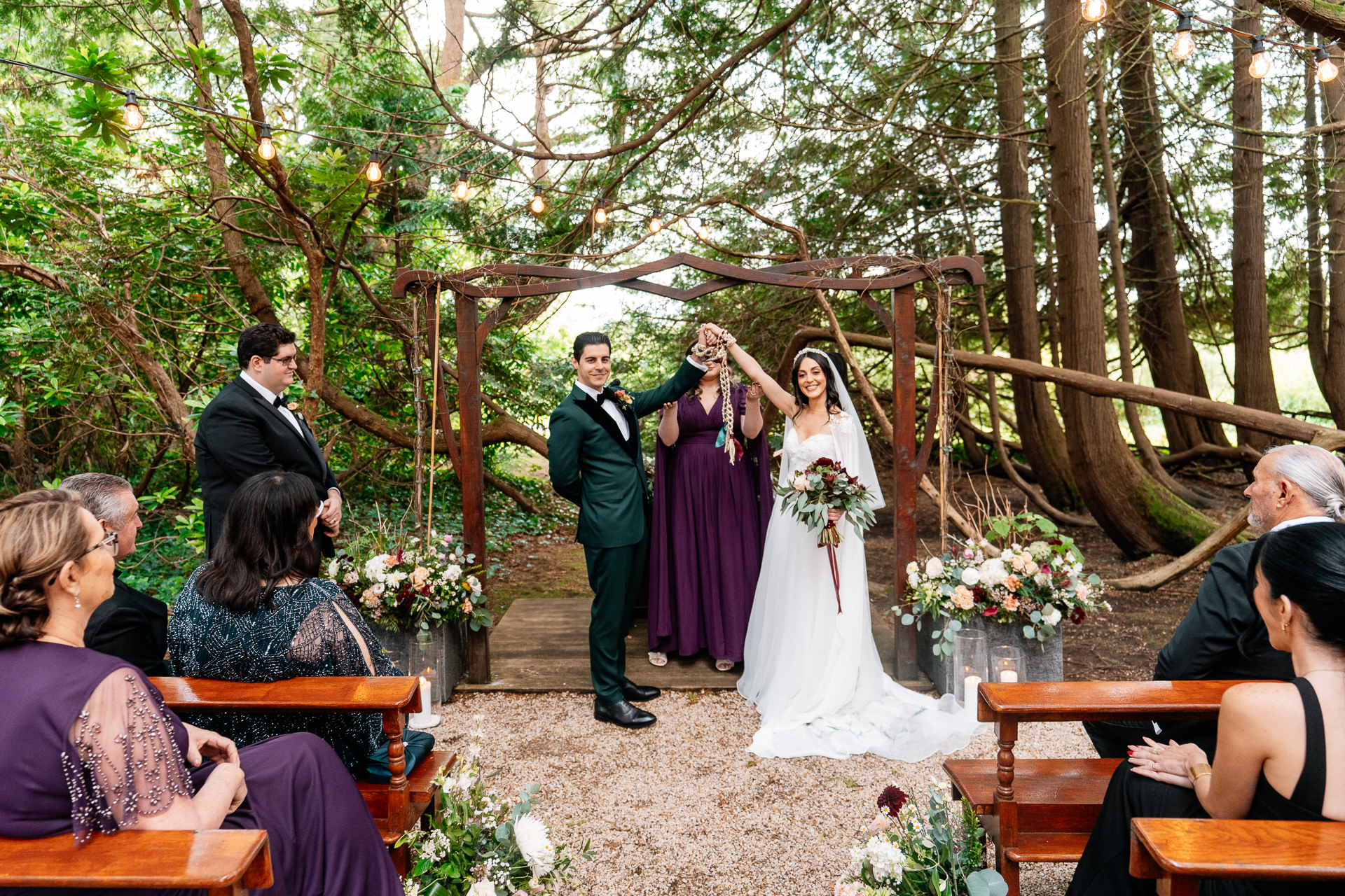 Bride and groom exchanging vows during a woodland ceremony in the forest clearing at Markree Castle