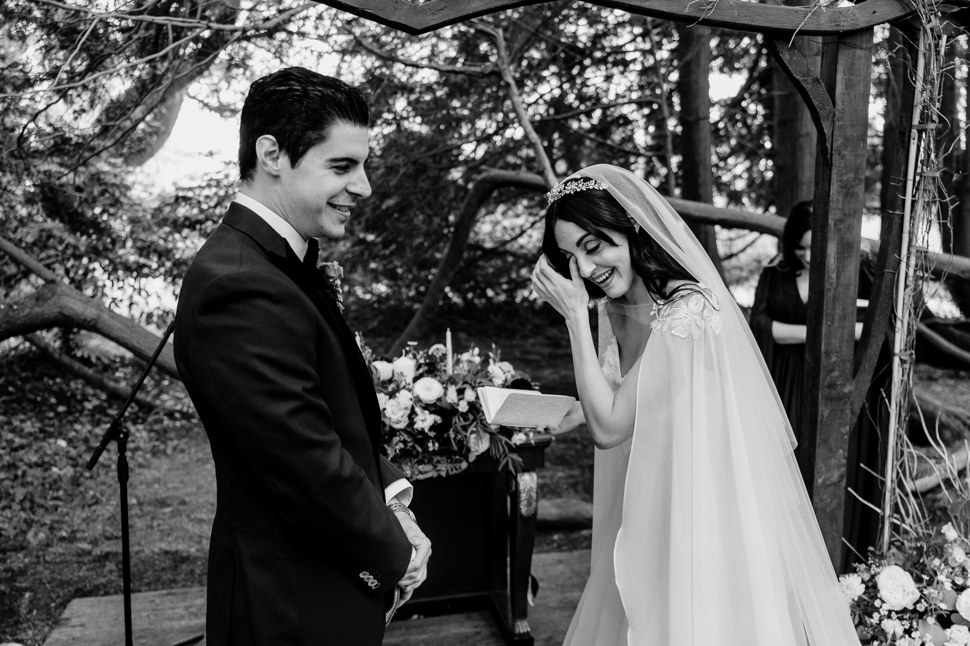 Bride and groom exchanging vows during a woodland ceremony in the forest clearing at Markree Castle