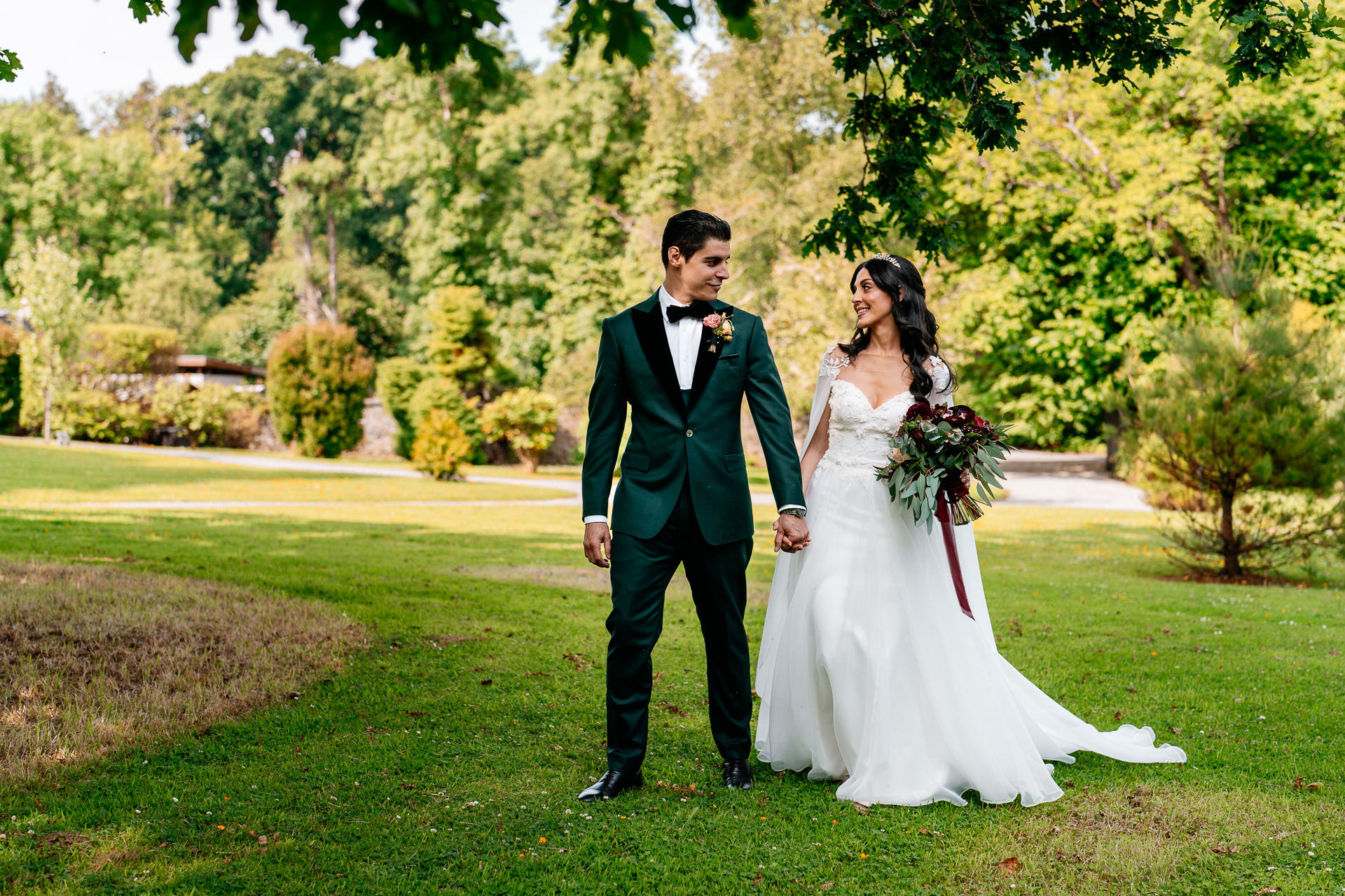 Bride and groom walking through the gardens of Markree Castle during their wedding portrait session